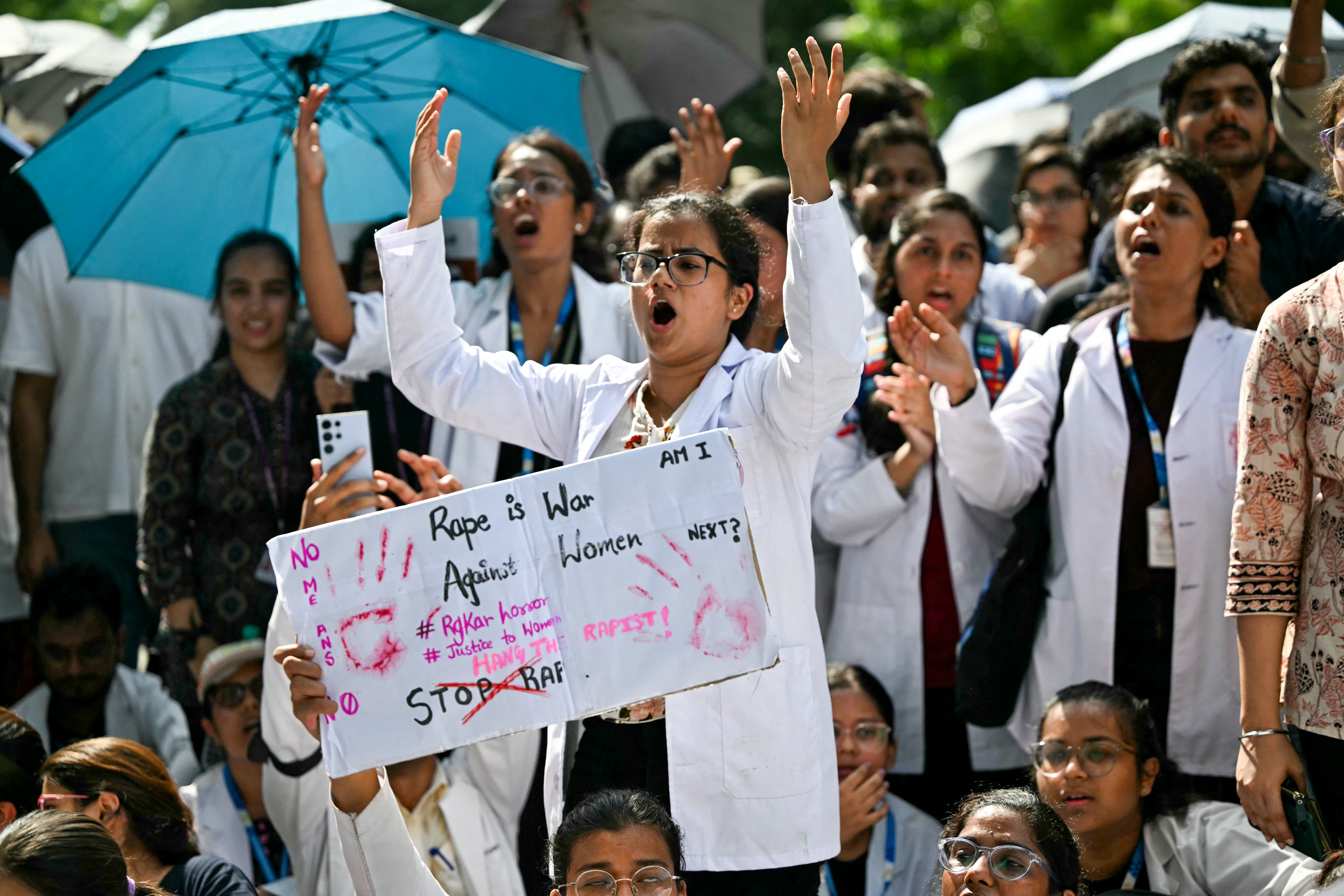 Medical professionals and students shout slogans as they condemn the rape and murder of a doctor in India's West Bengal state