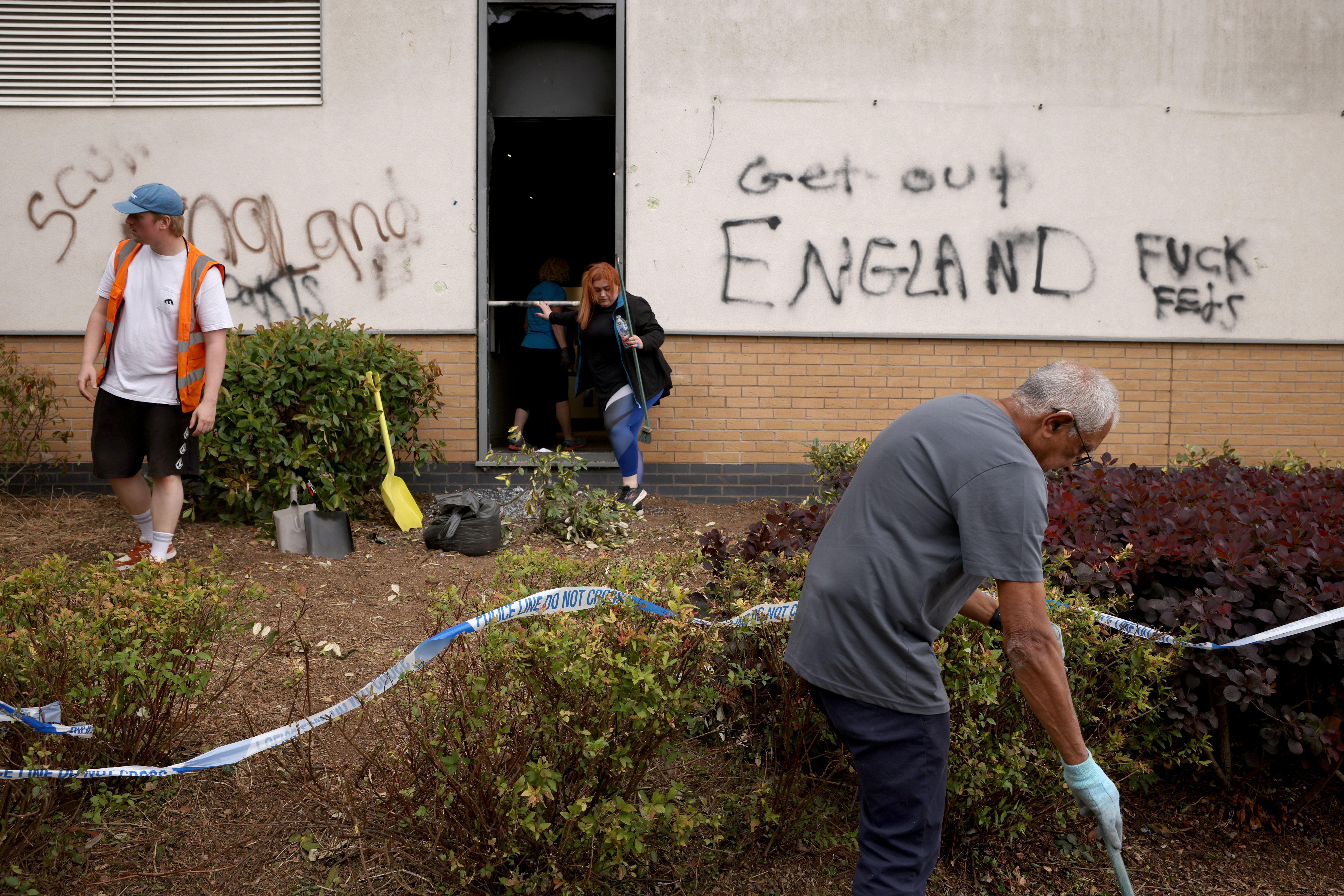 Locals clean up debris outside a Holiday Inn Express in Tamworth, Staffordshire