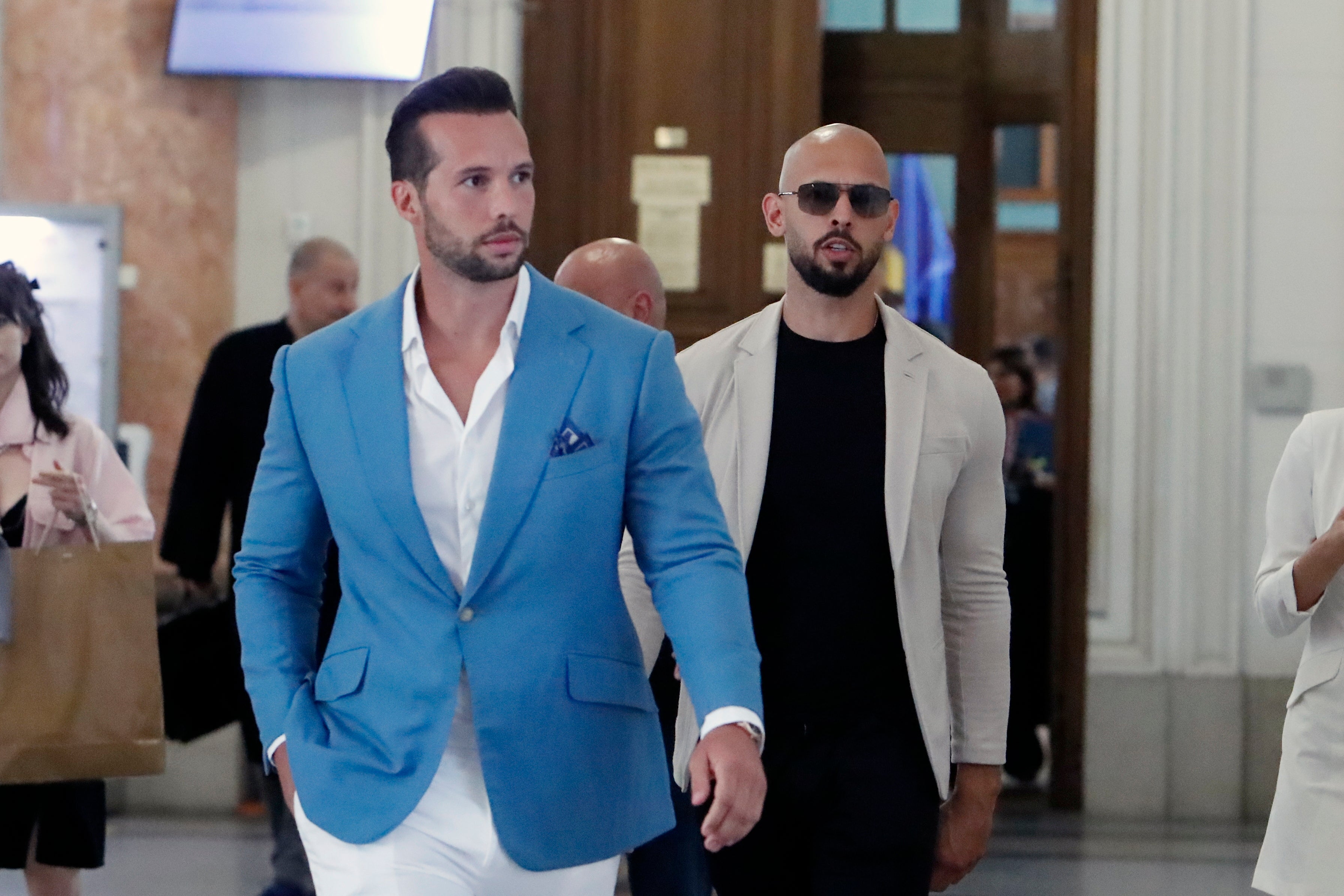 Andrew (right) and Tristan Tate leaving a court in June 2024