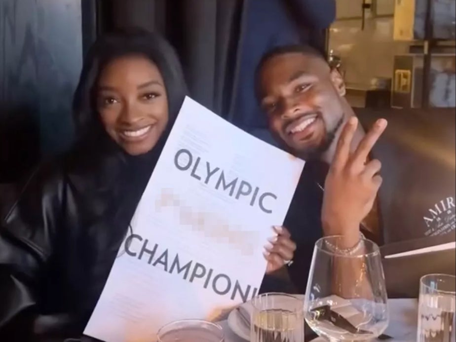 Simone Biles poses with husband at restaurant with menus reading ‘Olympic F***ing Champion’