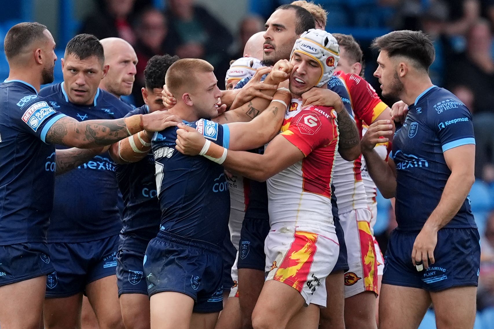 Hull KR’s Mikey Lewis (centre left) and Catalans Dragons’ Cesar Rouge (centre right) clash (Martin Rickett/PA).