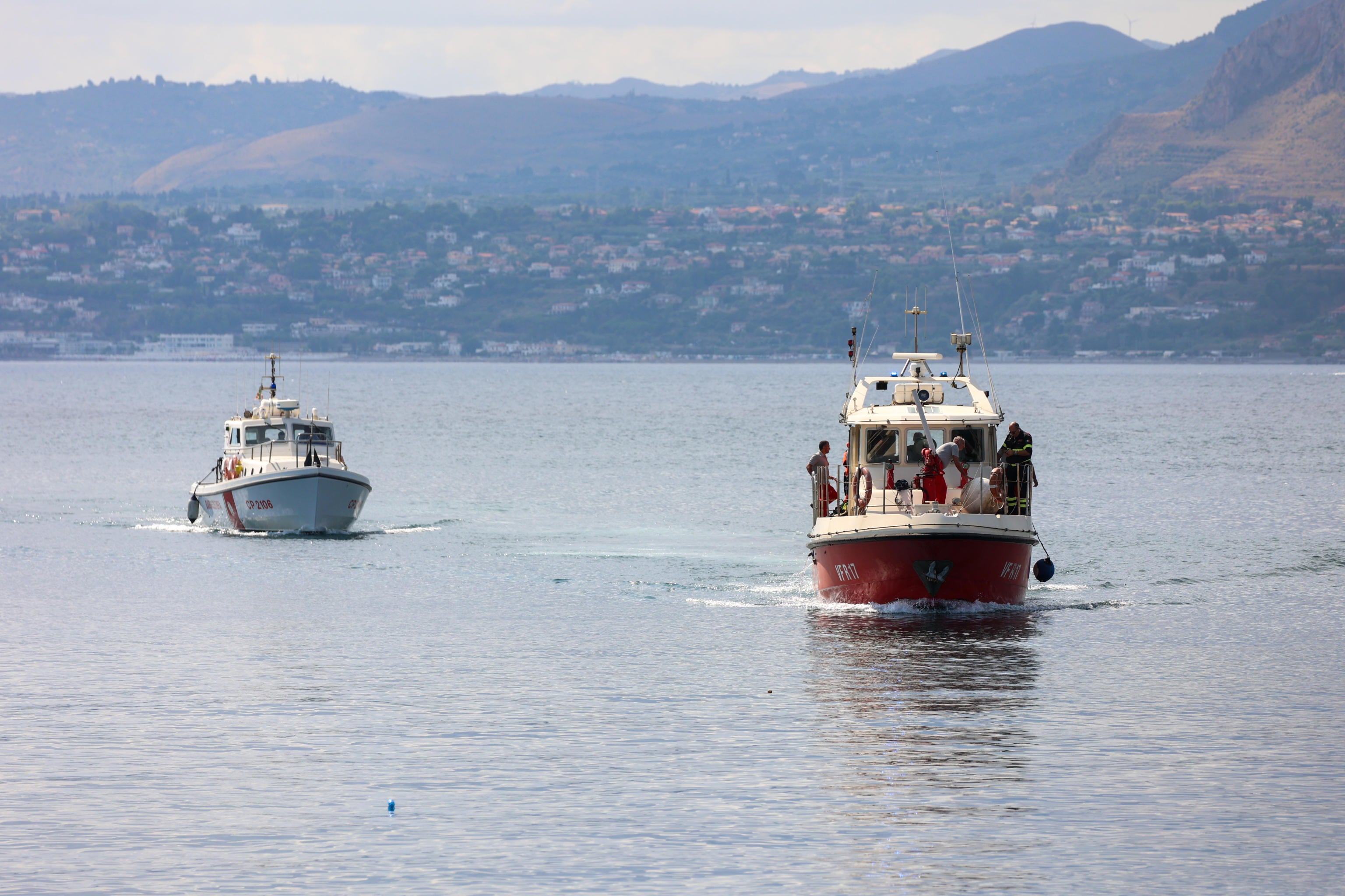 Boats are seen participating in the search efforts with specialist divers