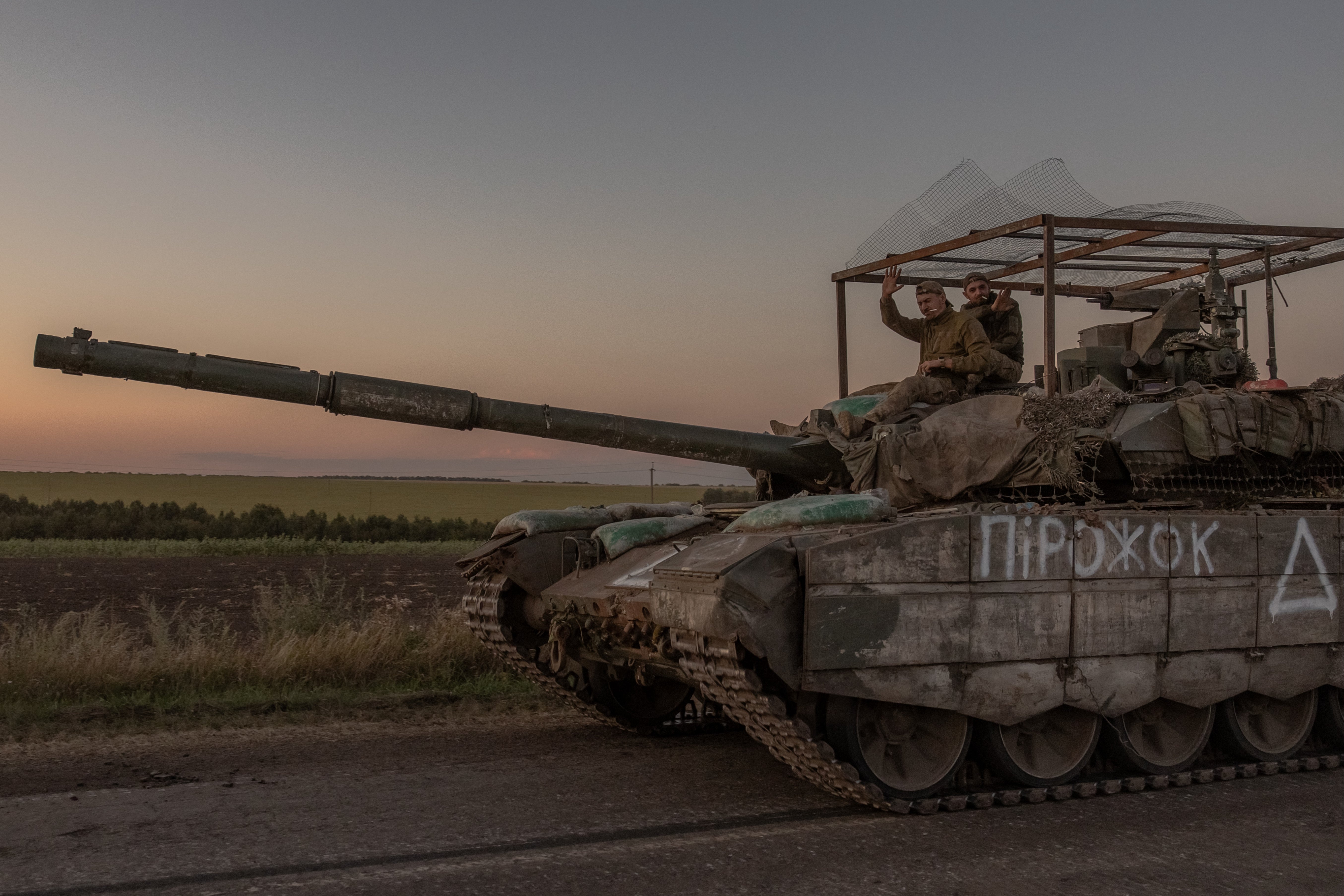 Ukrainian servicemen operate a tank on a road near the border with Russia