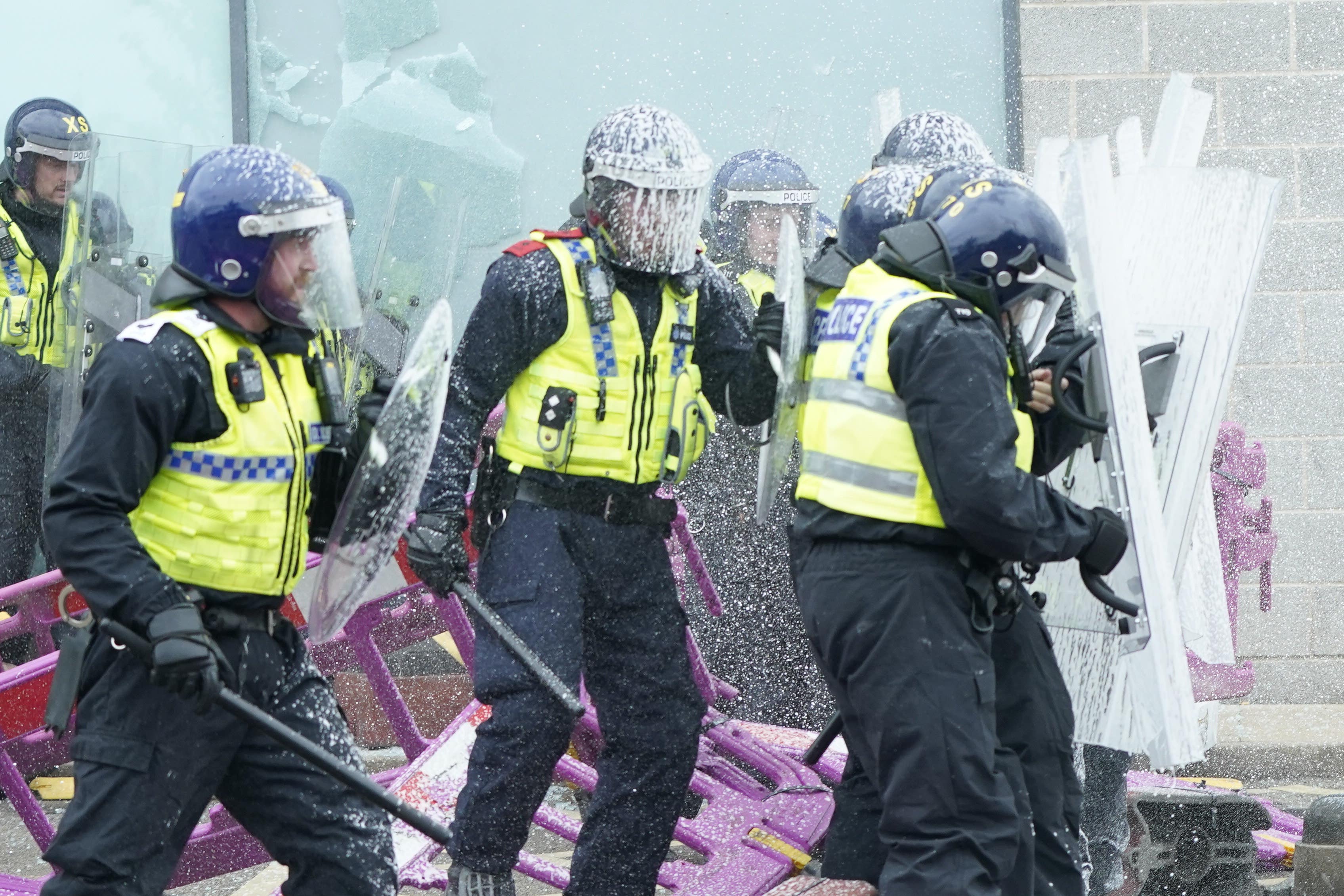 Fire extinguishers are used on police officers as trouble flares during an anti-immigration protest outside the Holiday Inn Express in Rotherham, South Yorkshire. Picture date: Sunday August 4, 2024.