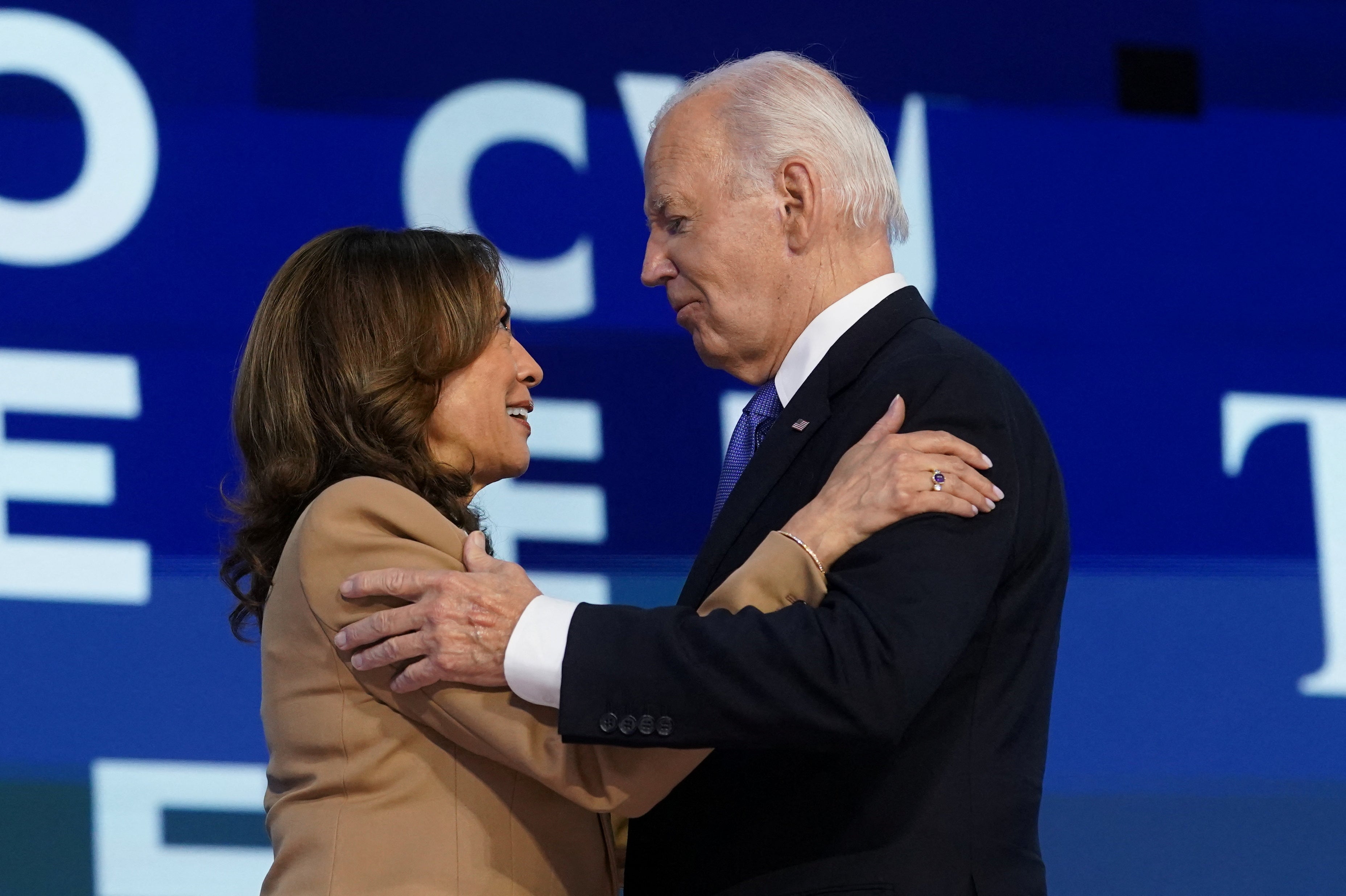 Joe Biden and Kamala Harris embrace after the president’s remarks at the Democratic National Convention