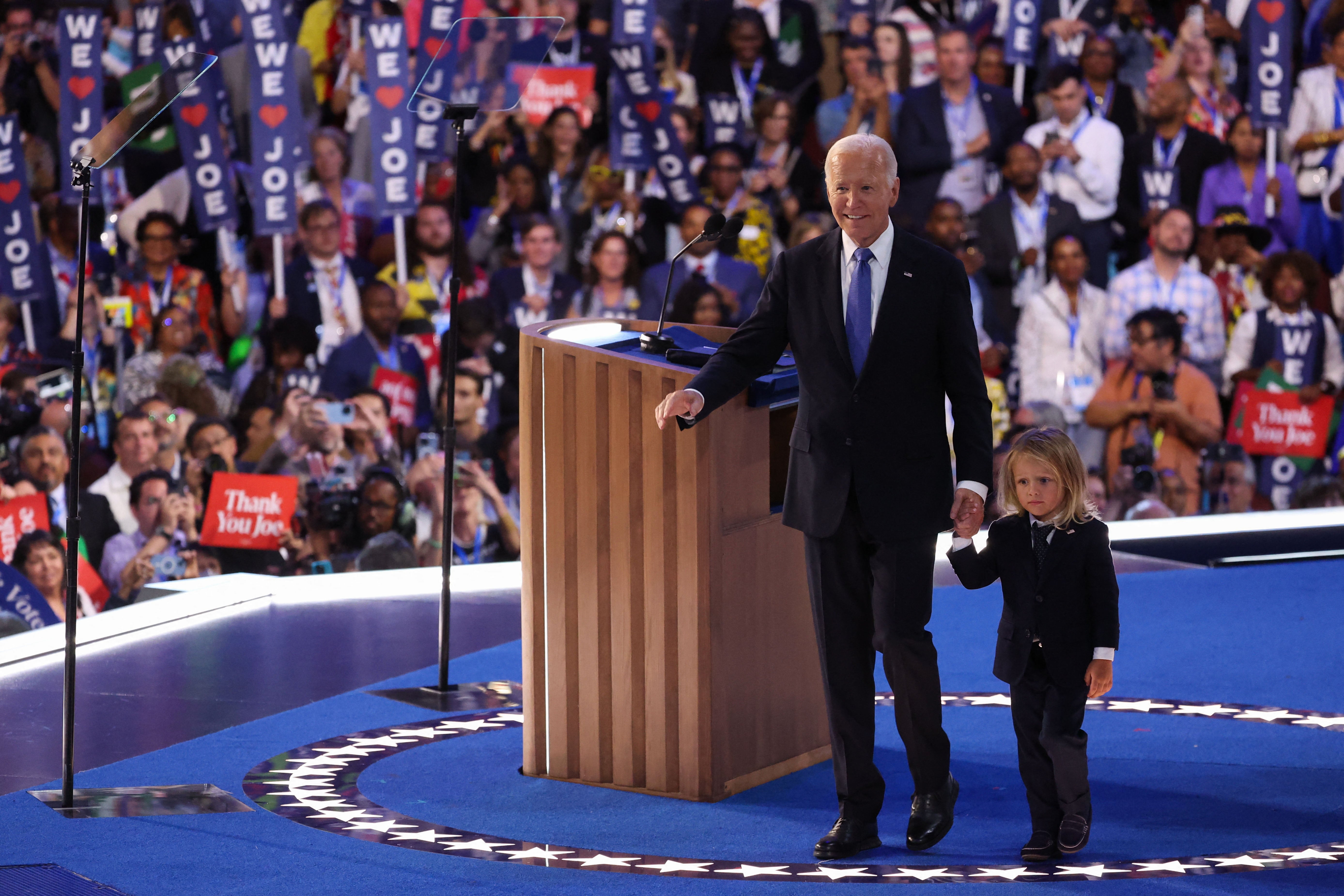 Joe Biden walks with his grandchild after his remarks to the Democratic National Convention