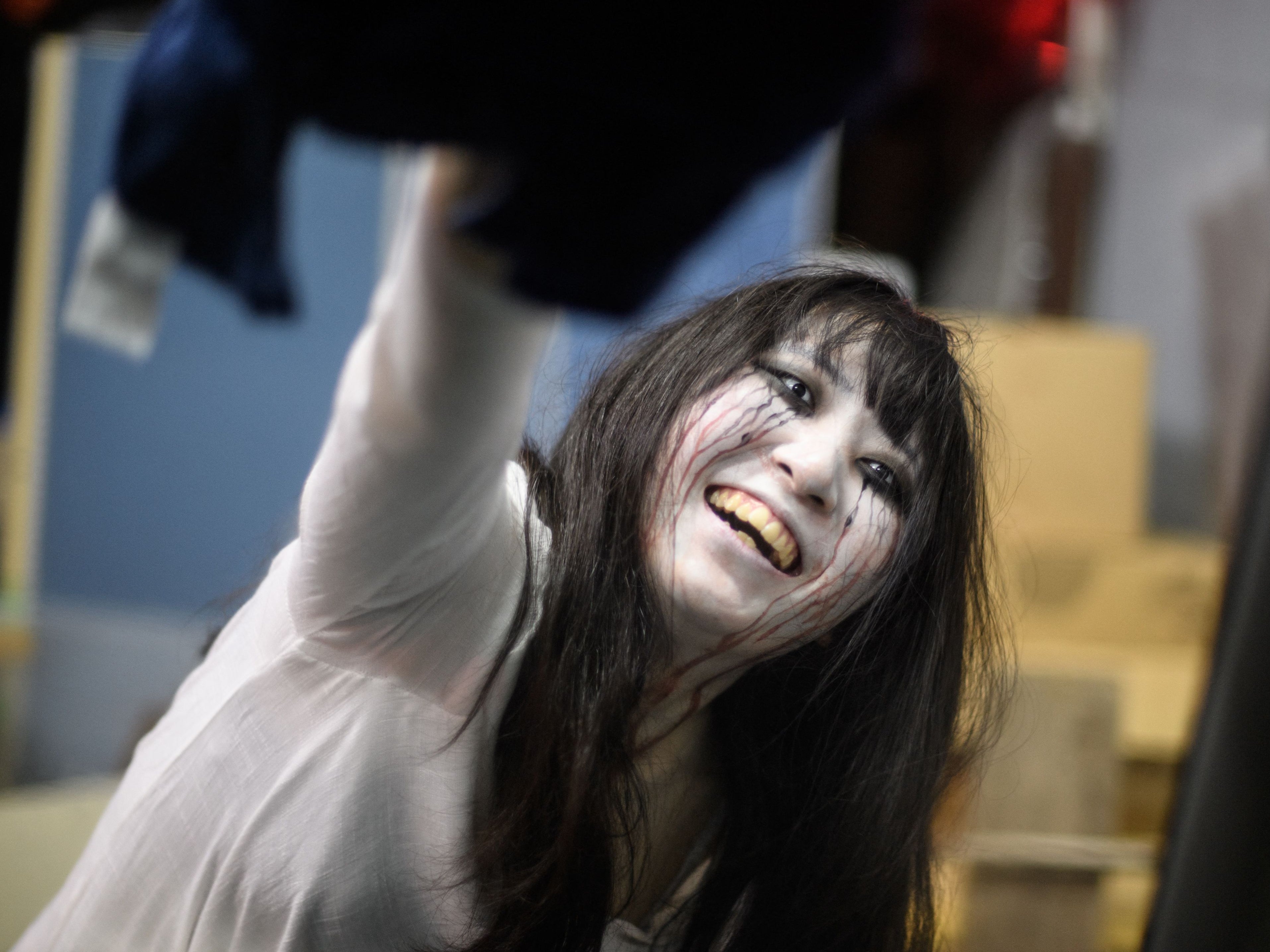 File. Actress Haruna Suzuki cleaning up fake blood from a car following a demonstration of a haunted house in Tokyo