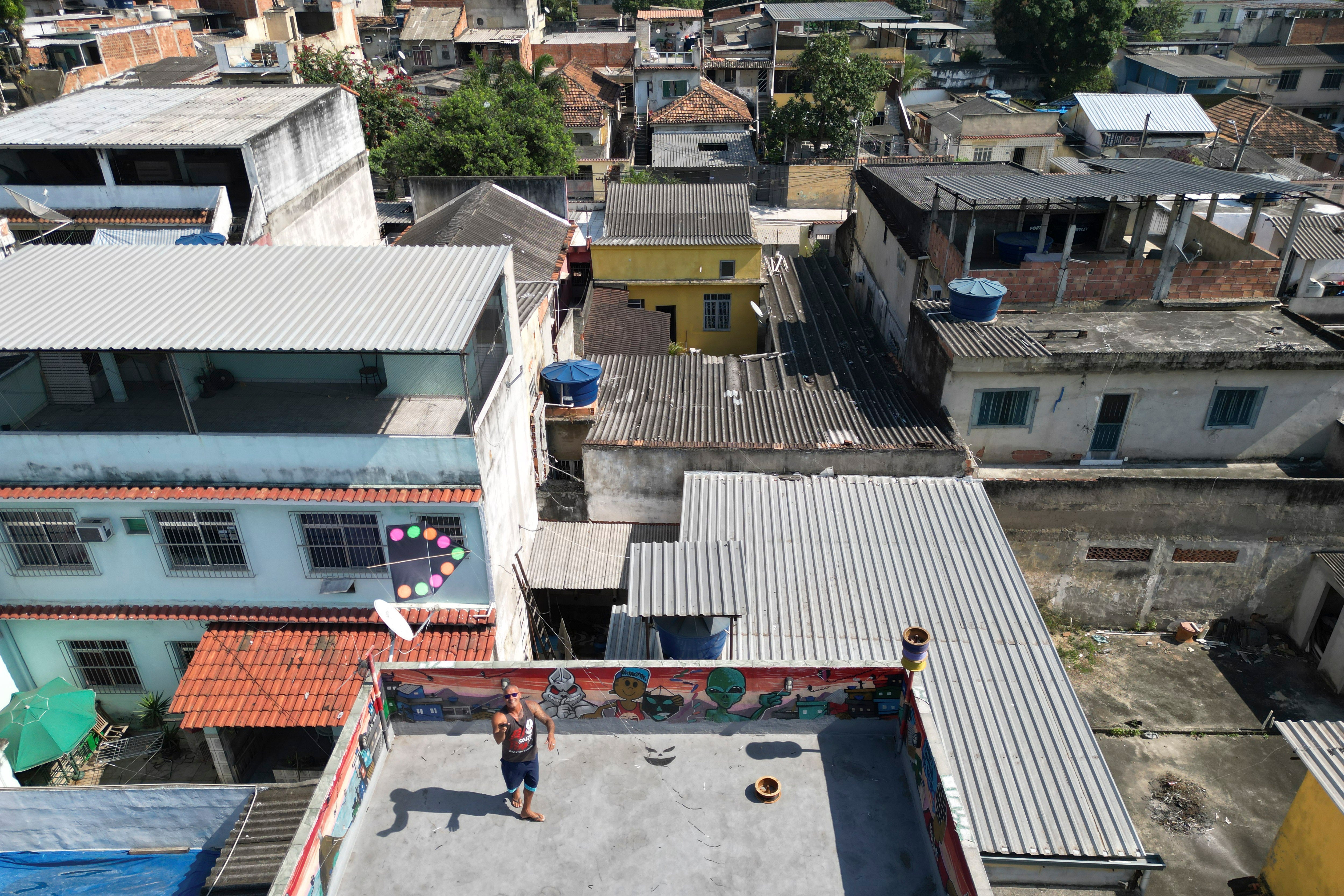 Alexander ‘Jarro’ Mattoso da Silva, a military police officer and the president of the Brazilian Sports Kite Association, flies a kite on his roof in Rio de Janeiro,