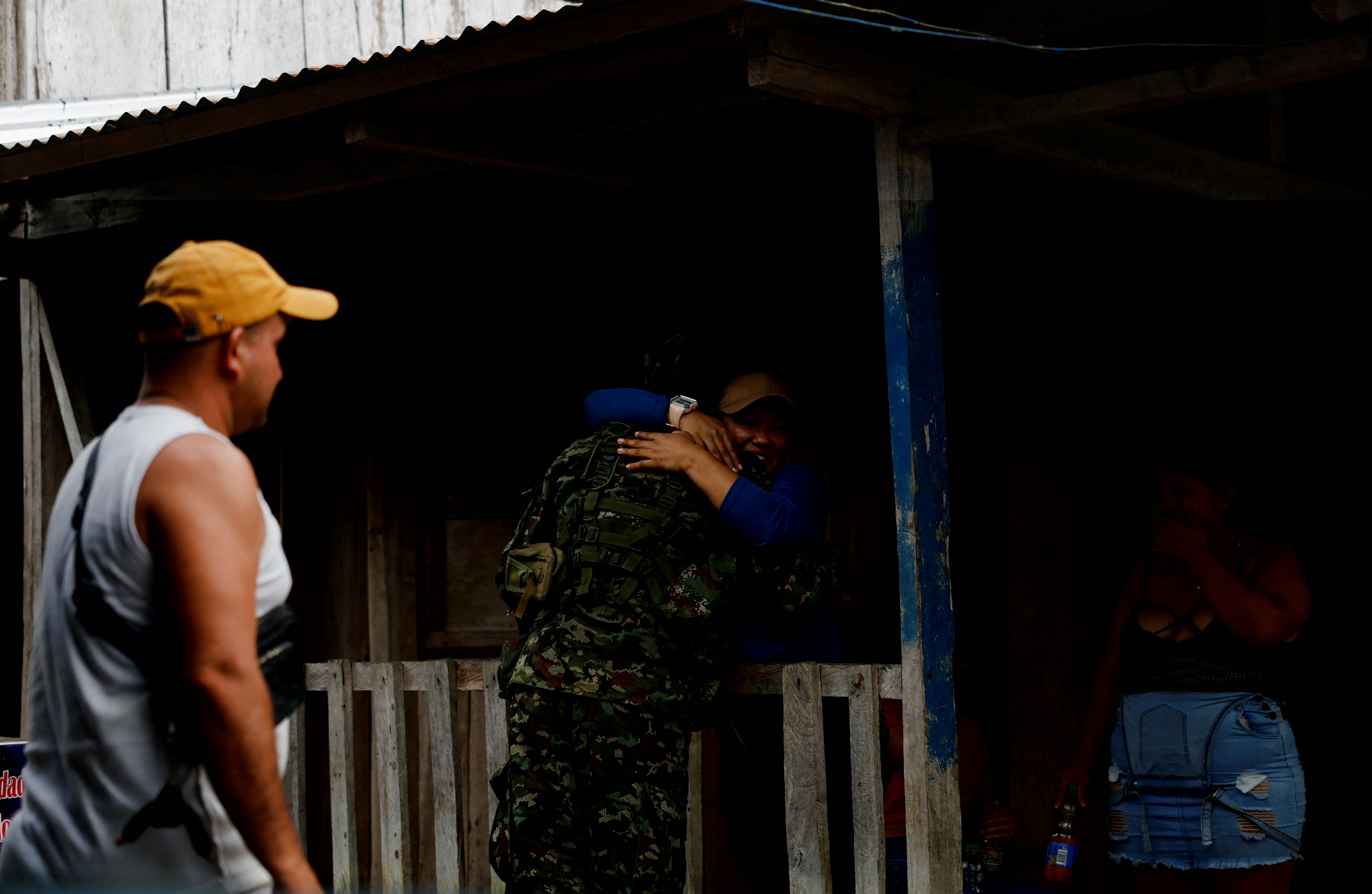 A resident hugs a guerrilla of Colombian rebel group Segunda Marquetalia, in Colombia’s Pacific jungle, Colombia,