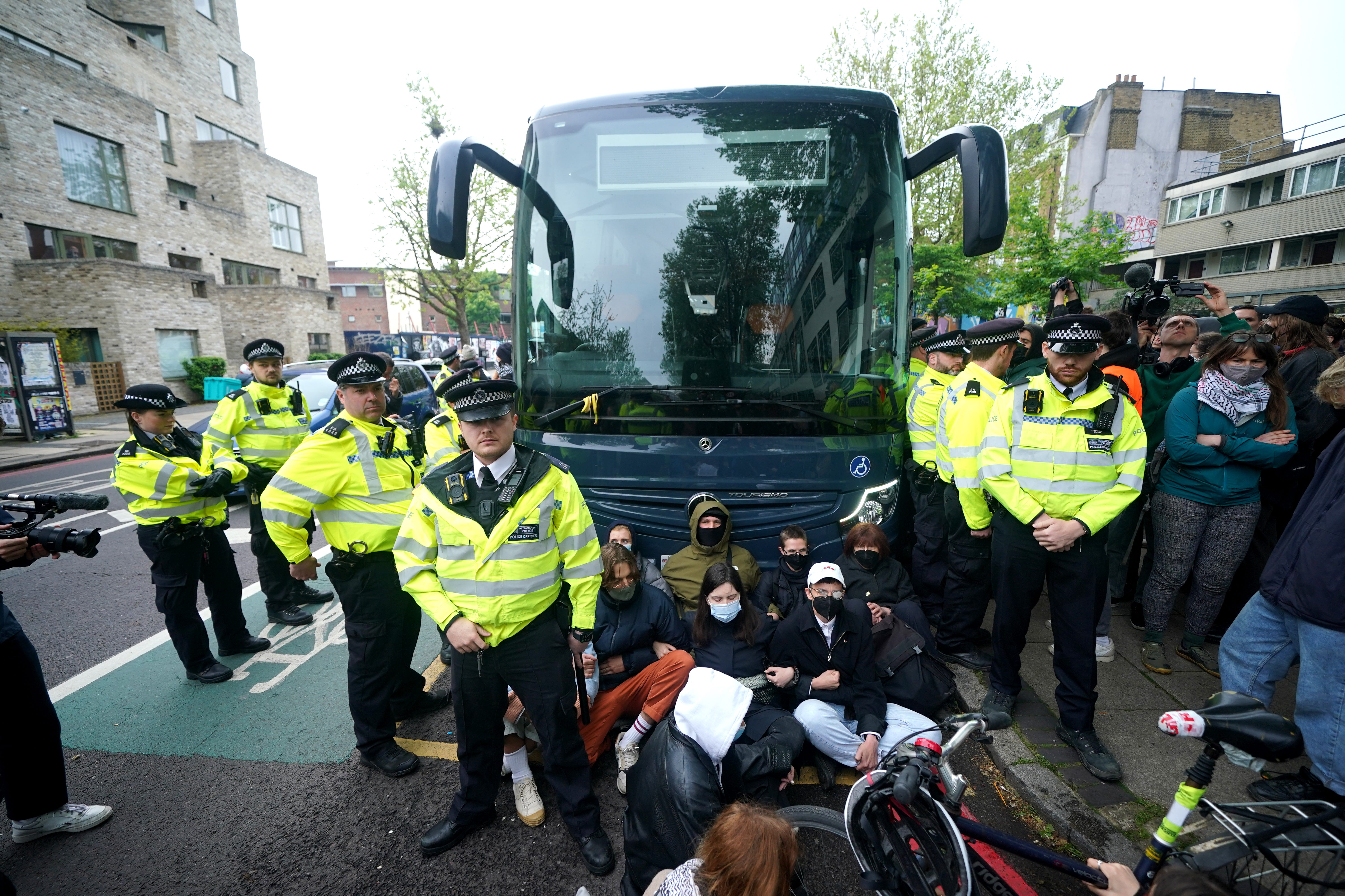 Police tried to stop protesters forming a blockade around the coach parked near the Best Western hotel in Peckham (Yui Mok/PA)