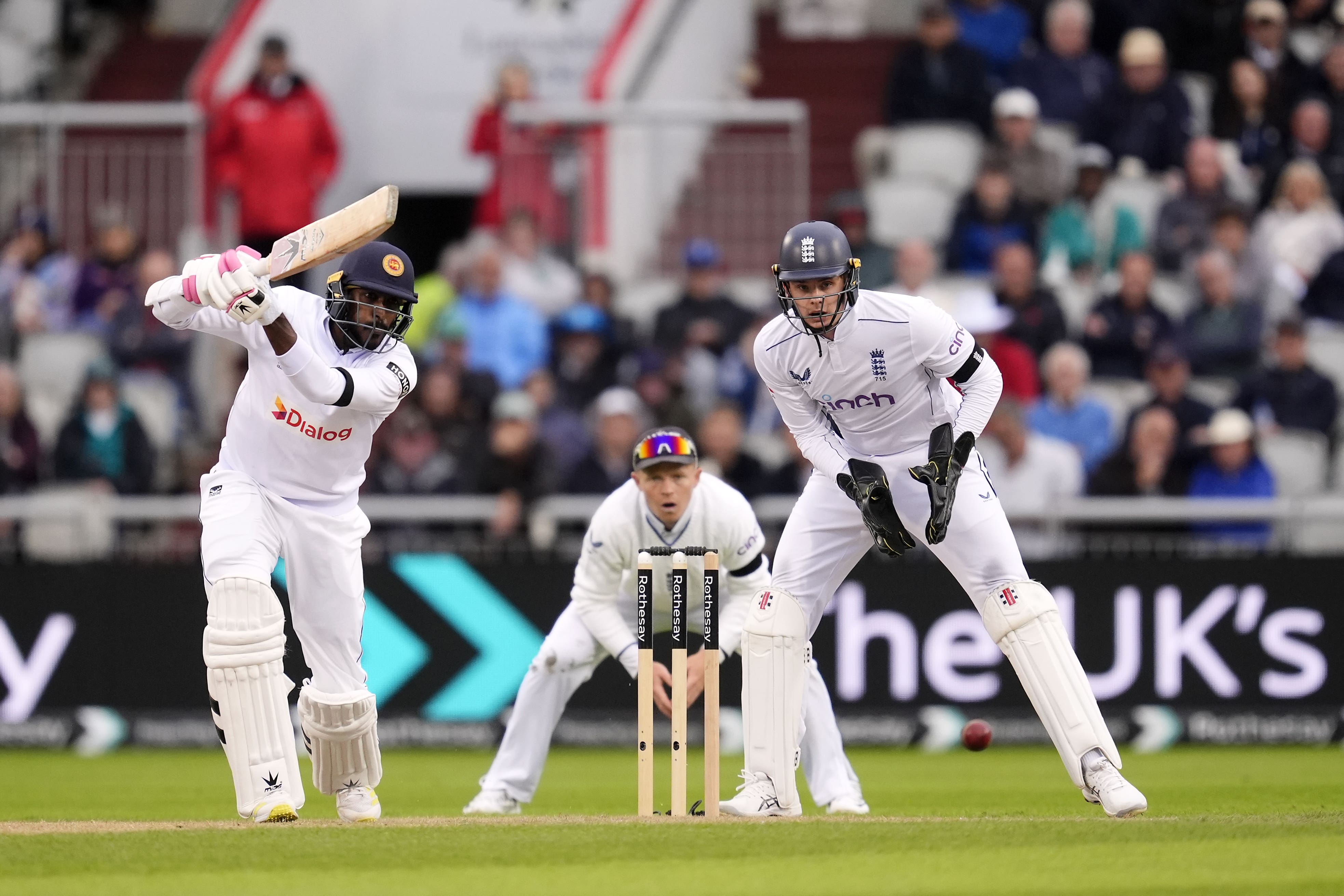 Milan Rathnayake hits a shot as wicketkeeper Jamie Smith and captain Pope watch on during day one of the First Rothesay Test match at the Emirates Old Trafford, Manchester