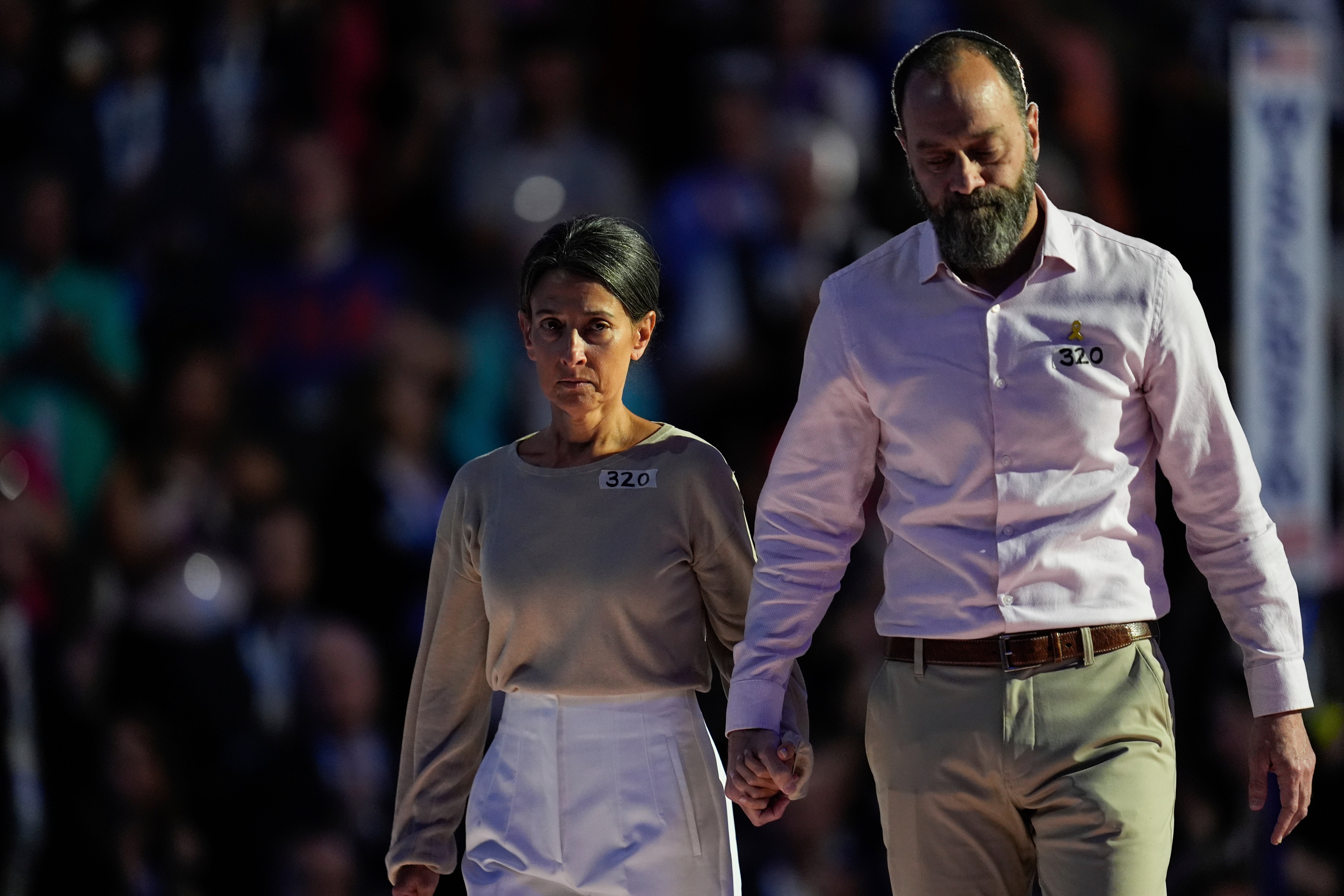 Jon Polin, right, and Rachel Goldberg, parents of hostage Hersh Goldberg-Polin walk off the stage after speaking during the Democratic National Convention Wednesday, 21 Aug 2024, in Chicago