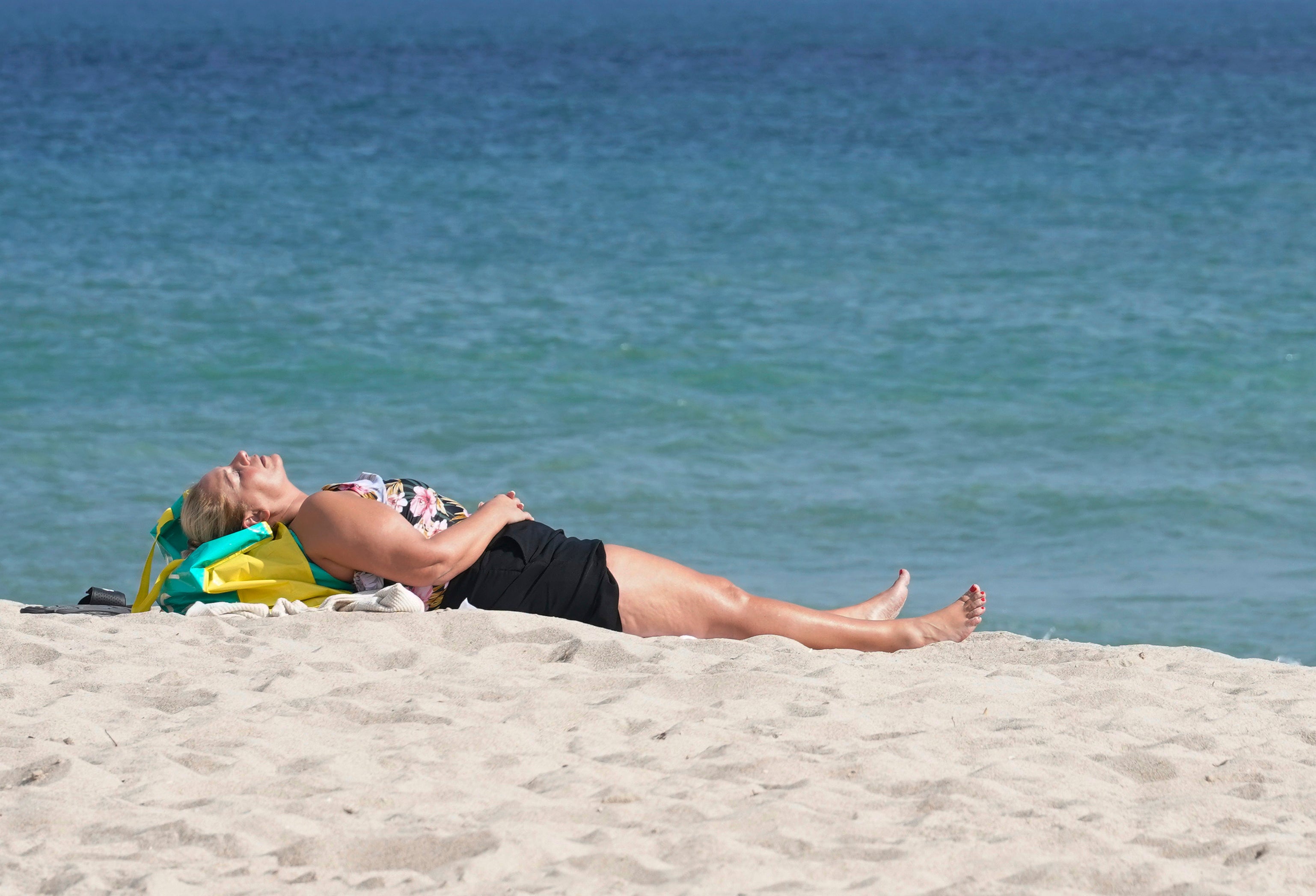 A beachgoer takes a nap on Fort Lauderdale beach