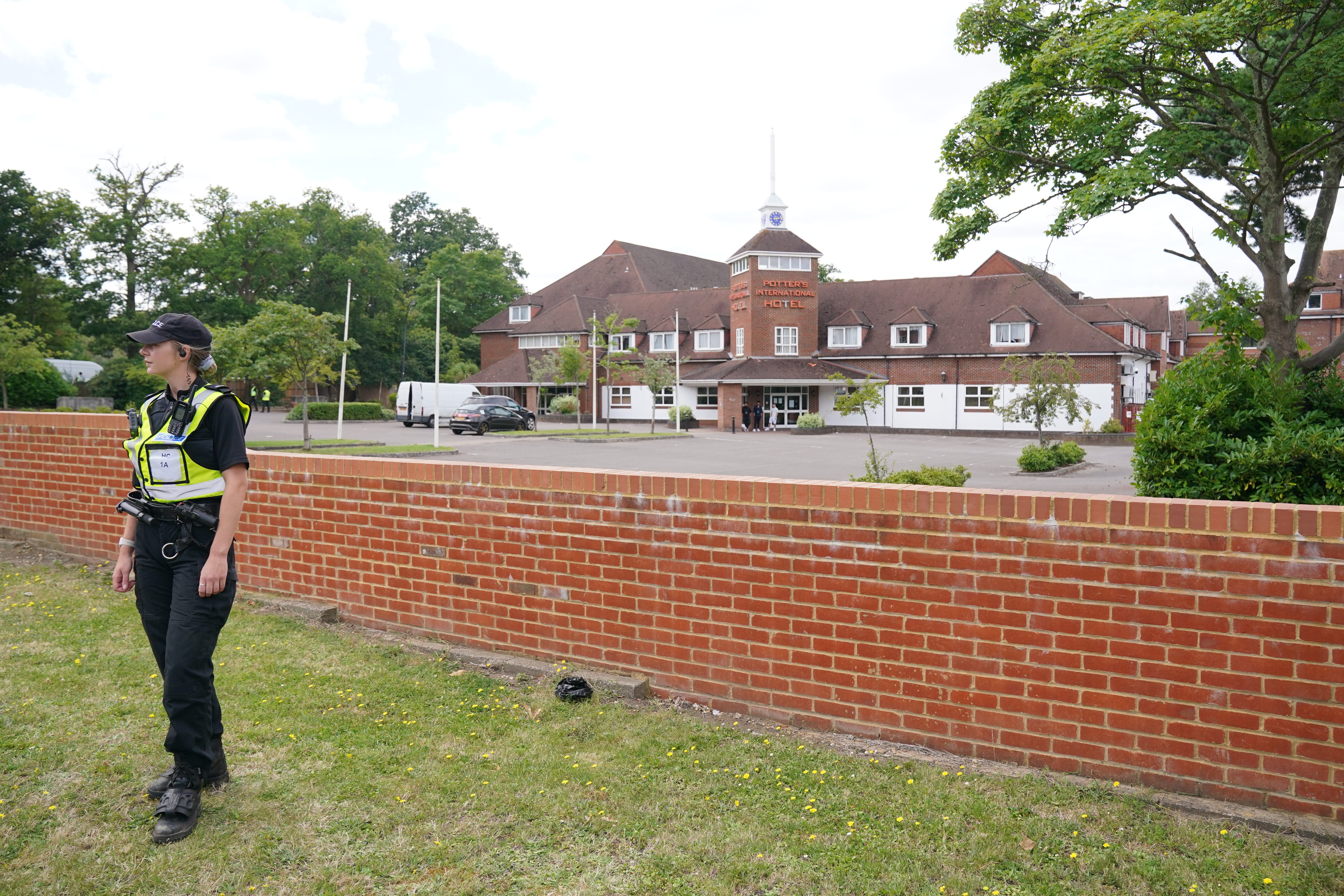 Police officers outside the Potters International Hotel in Aldershot (Jonathna Brady/PA)