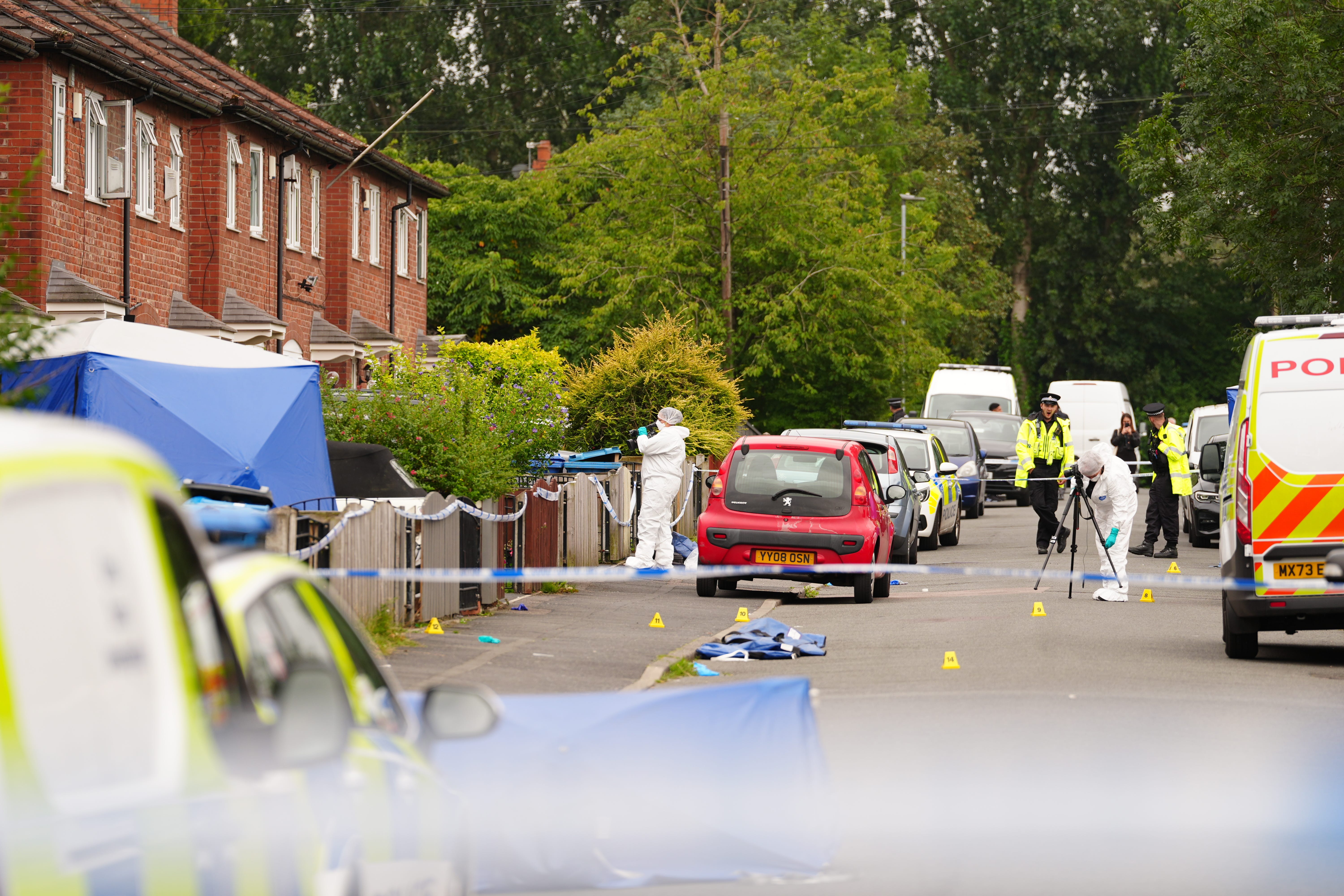 Forensic officers near a property in Barnard Road in Gorton, Manchester (Peter Byrne/PA)