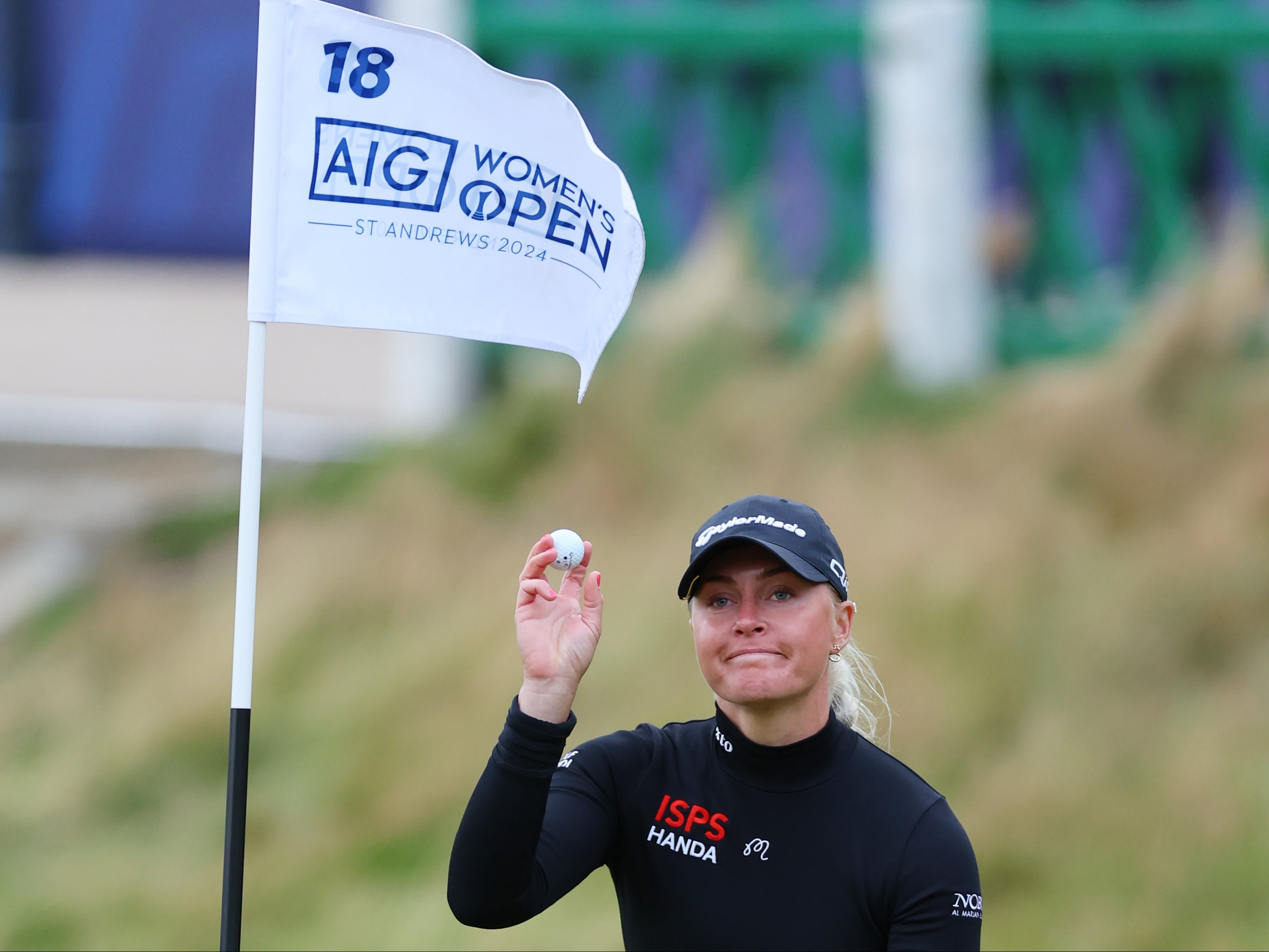 Charley Hull of England reacts to her birdie on the 18th green