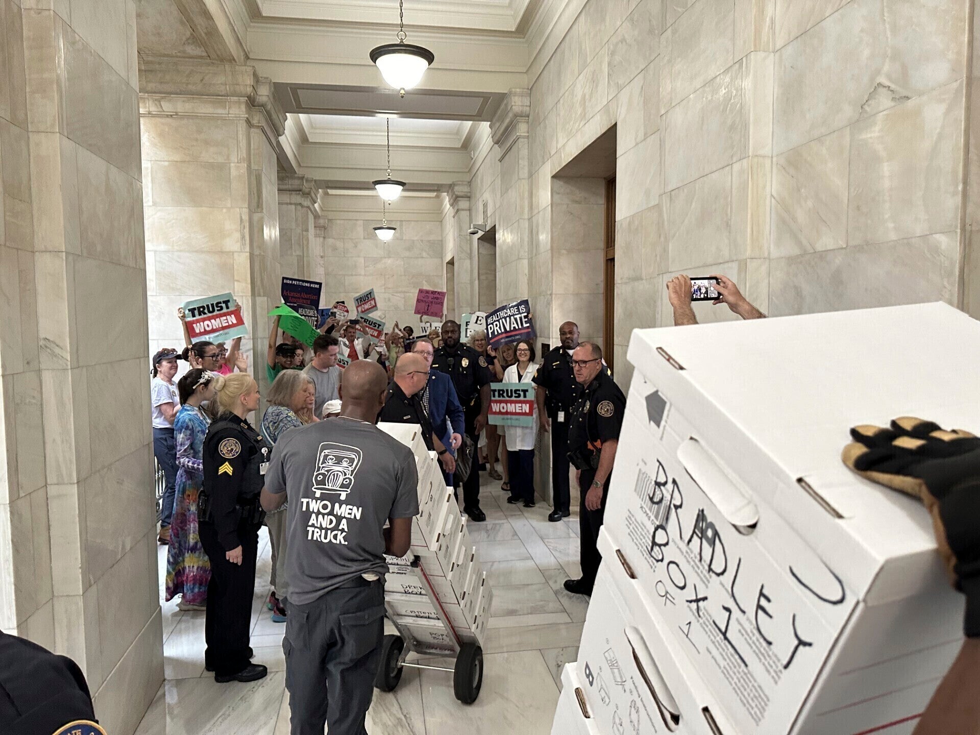 Boxes containing signatures supporting a proposed ballot measure to scale back Arkansas' abortion ban are delivered to a room in the state Capitol on July 5