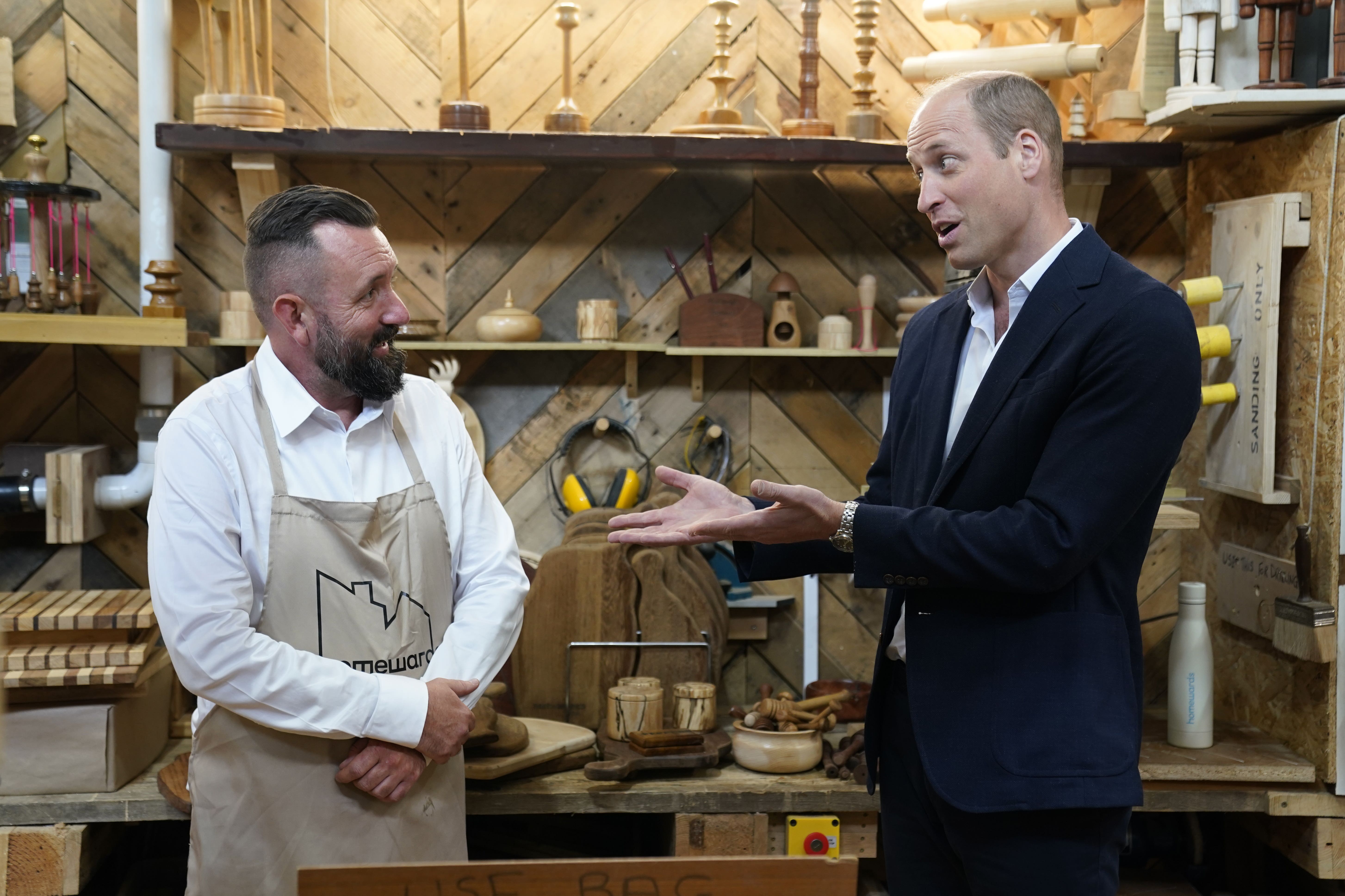 The Prince of Wales (right) with trainer Rob Cox during a visit to Faithworks Carpentry Workshop in Bournemouth, Dorset (Andrew Matthews/PA)