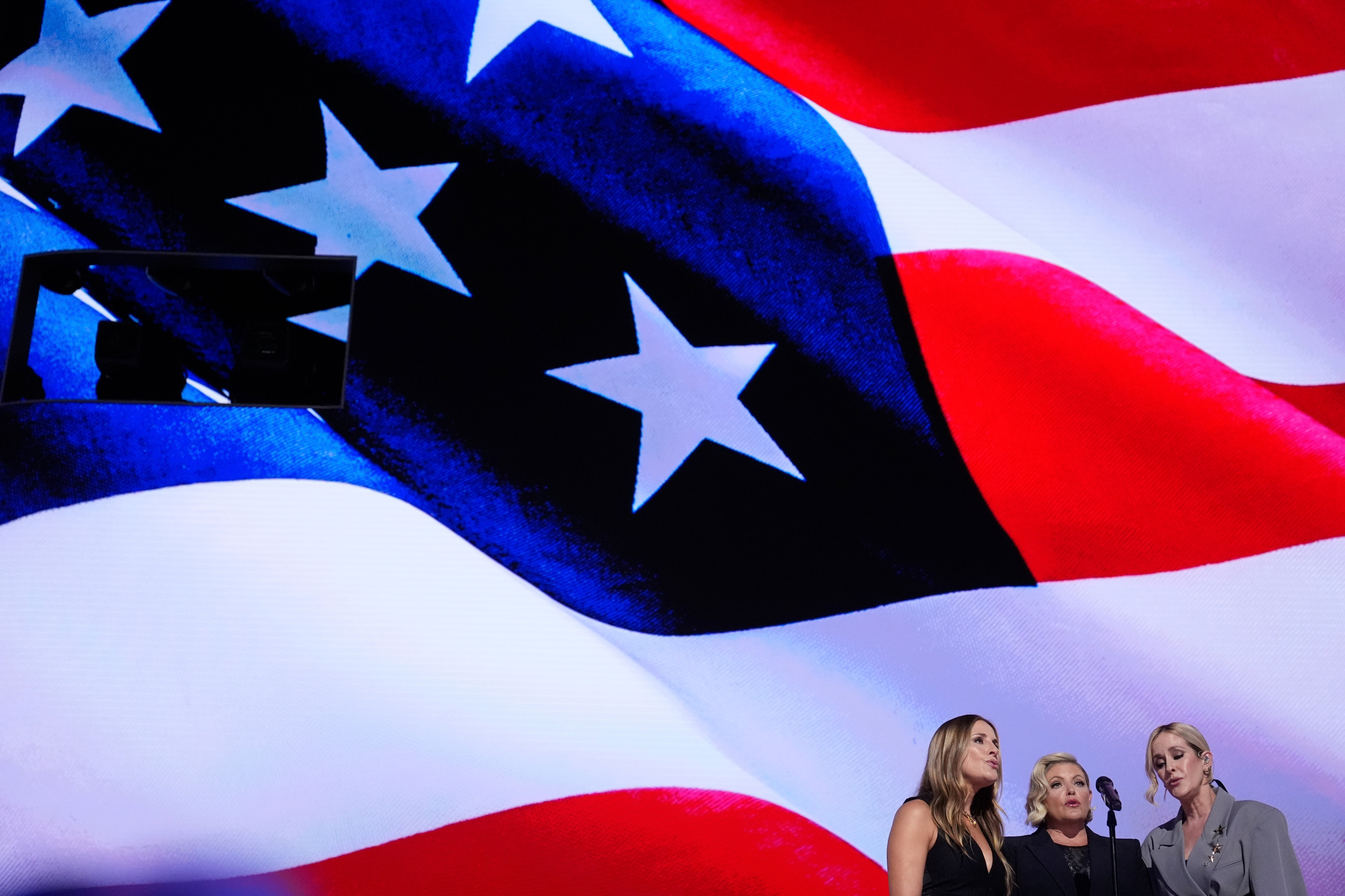 Emily Robison, from left, Natalie Maines and Martie Maguire, of The Chicks, sing the national anthem during the Democratic National Convention