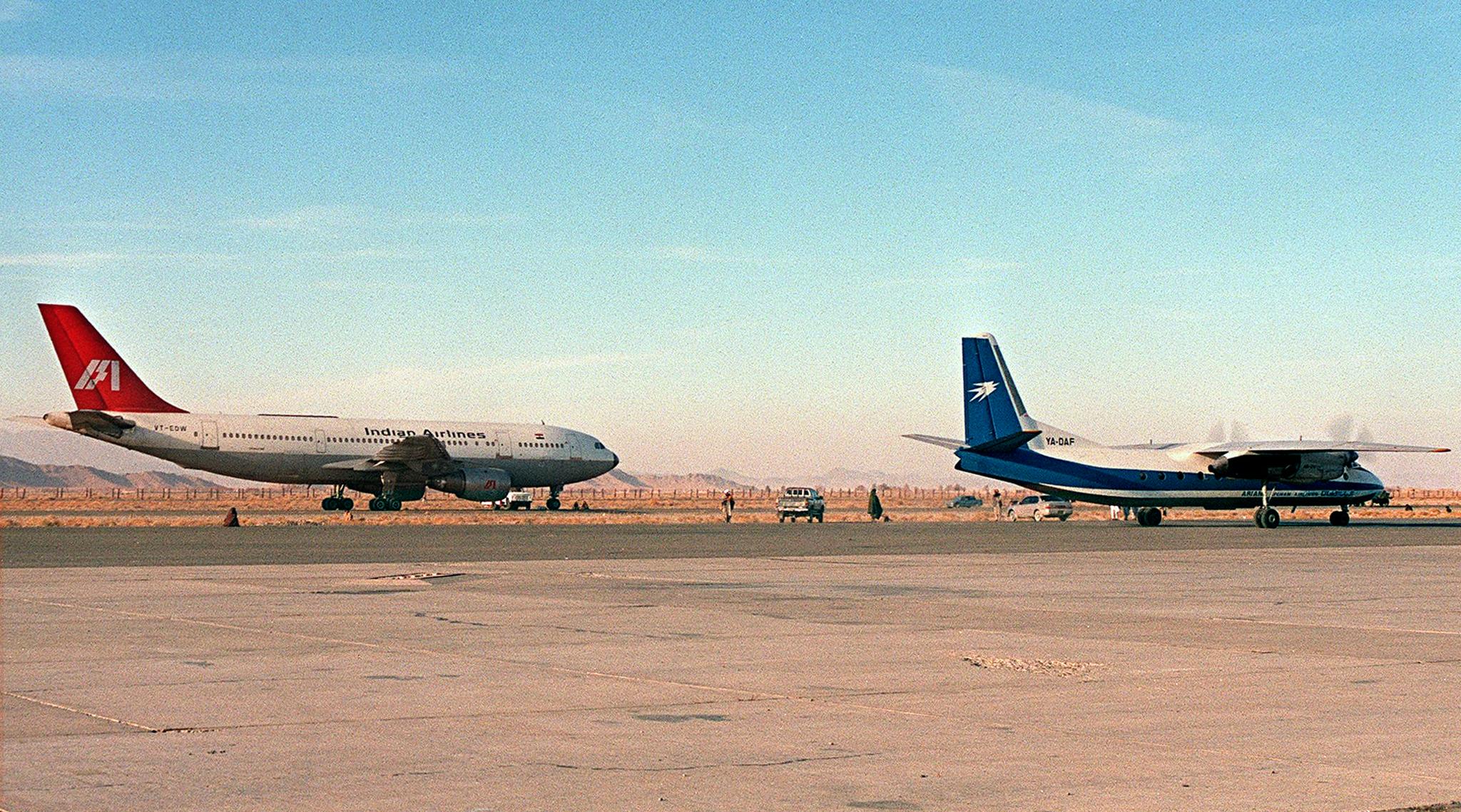 The hijacked Indian Airlines Airbus A300 (left) sits parked on the tarmac, at Kandahar airport in southern Afghanistan on 26 December 1999