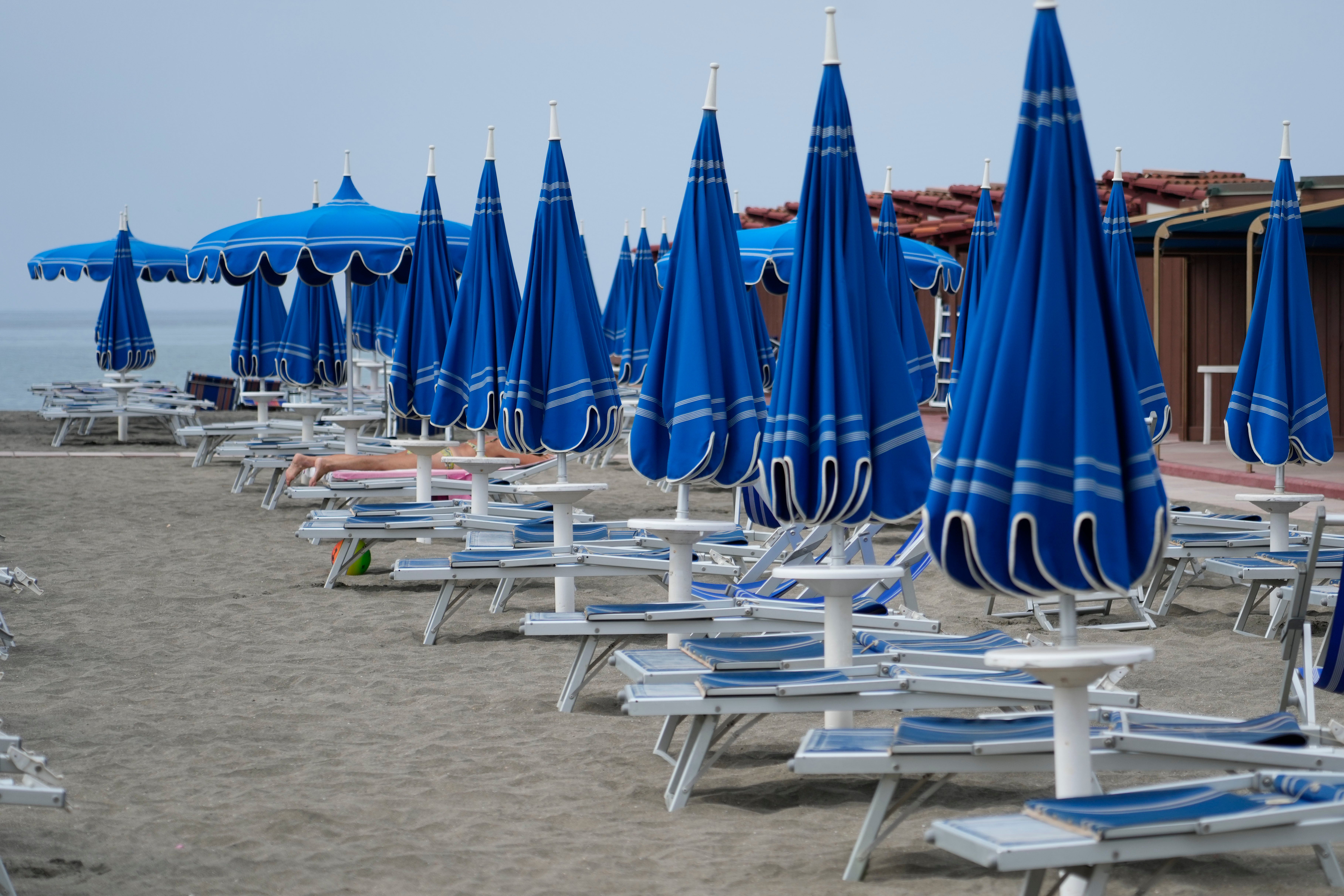 Umbrellas and sun beds are set at the Venezia beach establishment in Ostia, near Rome