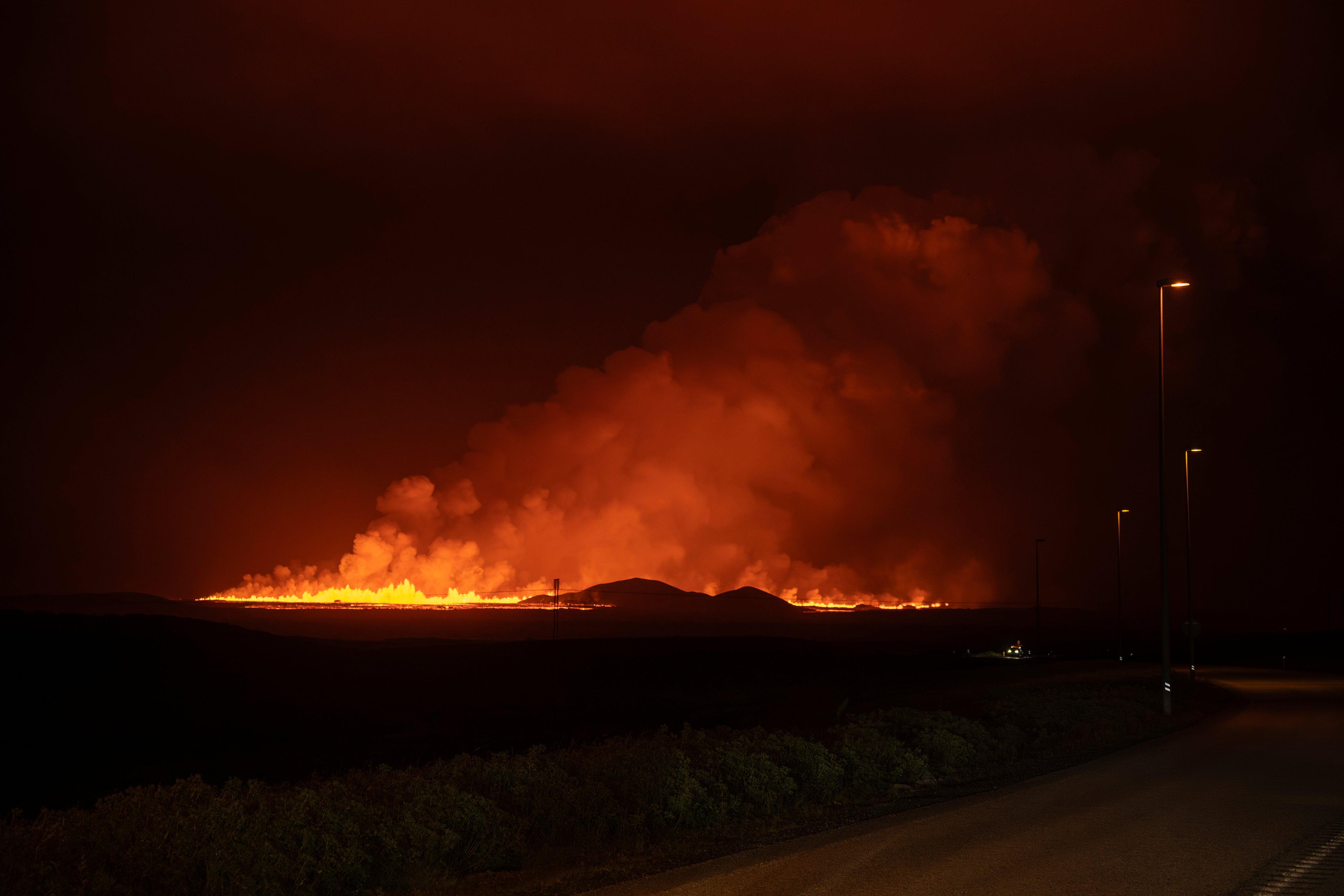 A new volcanic eruption is seen from the intersection between Reykjanesbraut, Iceland, and the road to Grindavik, Thursday, 22 August2024