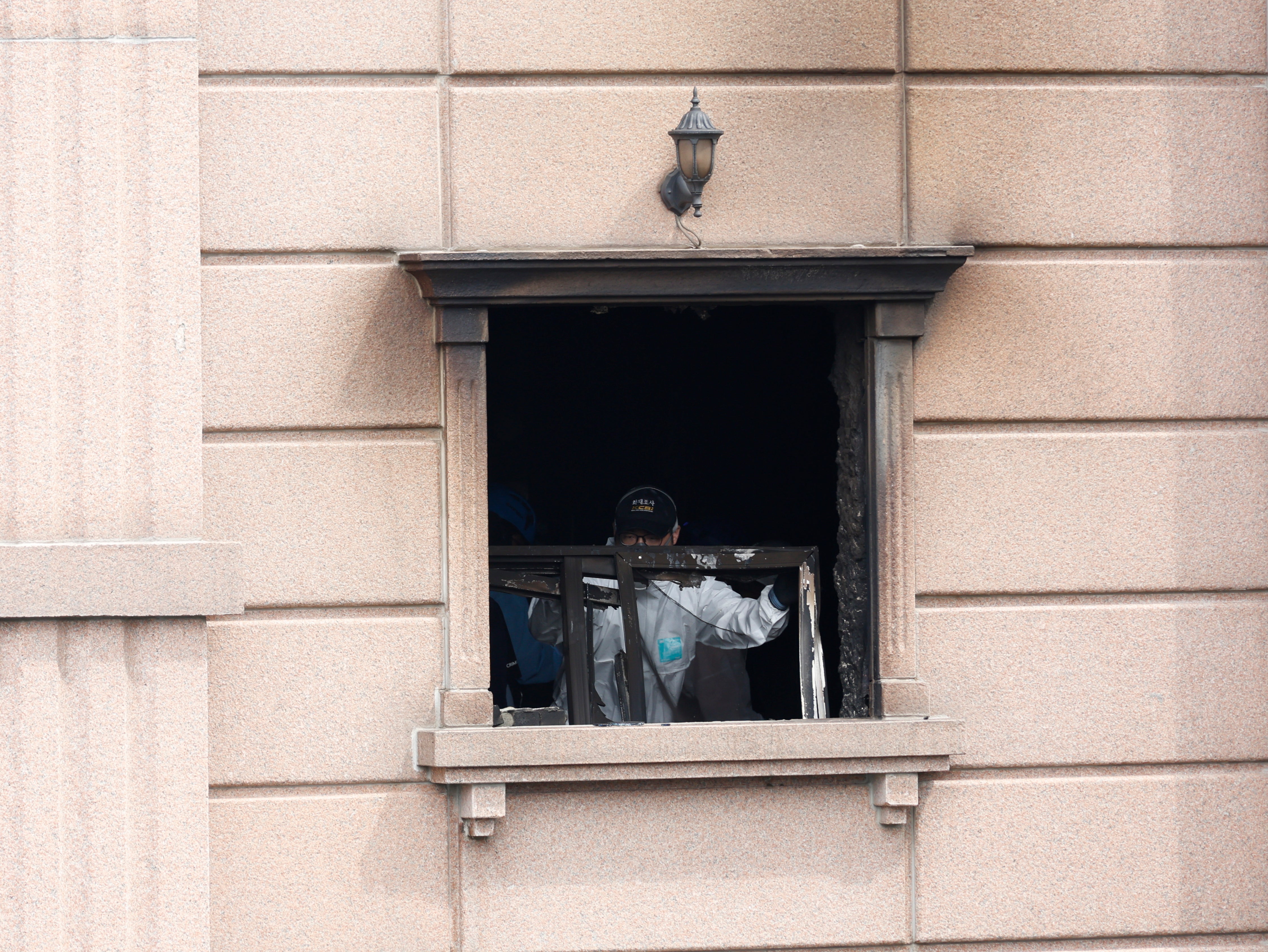 A joint investigation team examines the site of a fire at a hotel in Bucheon, around 25 km west of Seoul, South Korea, 23 August 2024