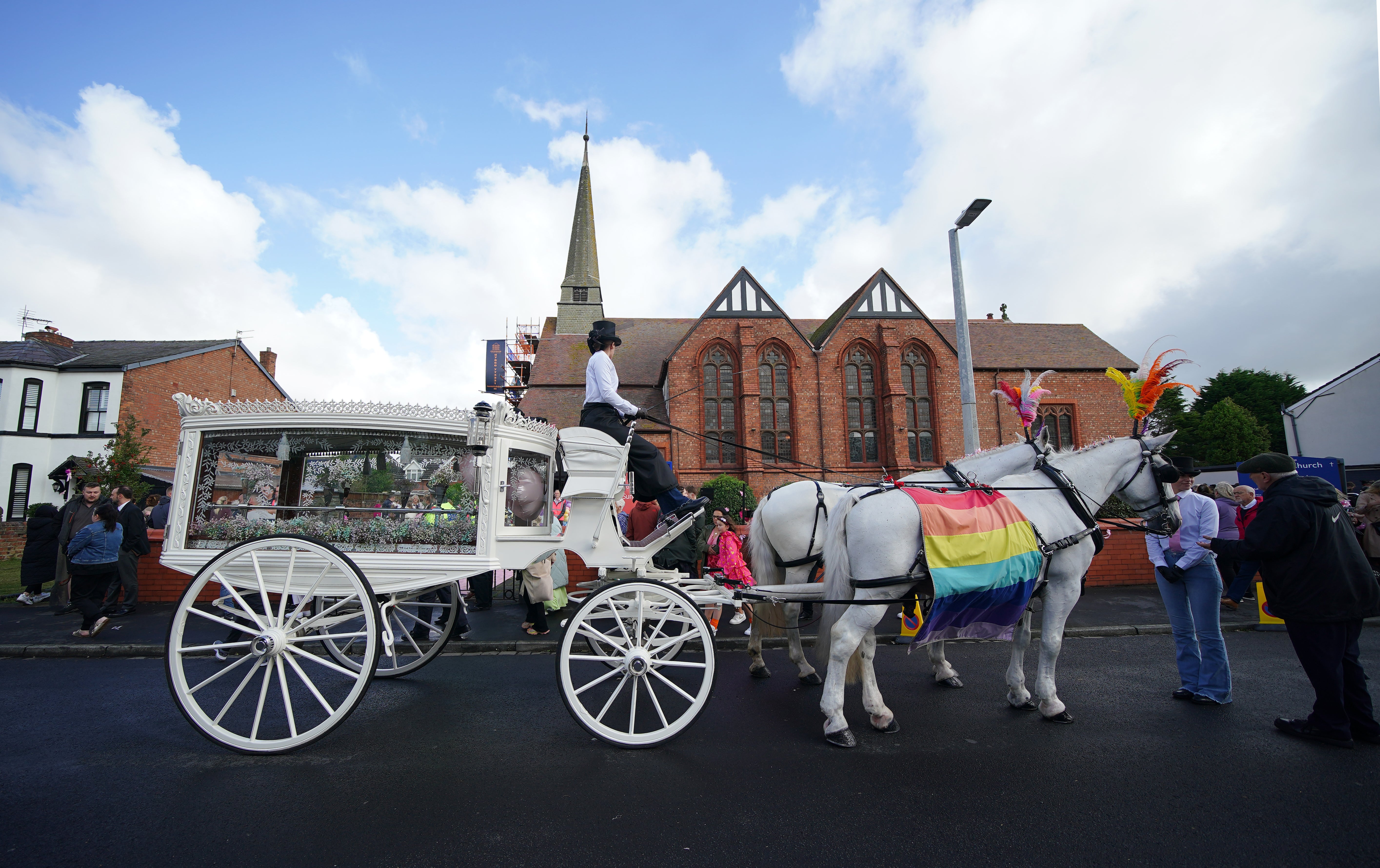 The carriage awaited outside while the funeral was ongoing