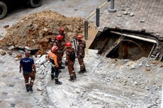 Woman plunges into 8m-deep sinkhole after pavement collapses