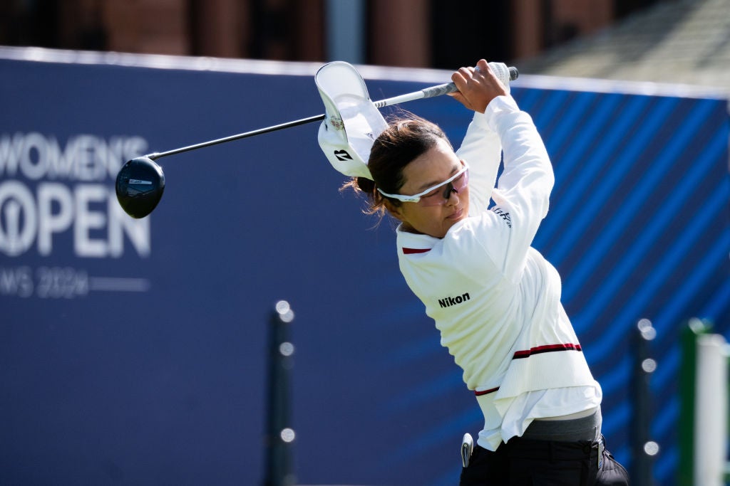 Jin Young Ko of South Korea loses her hat to the wind while teeing off