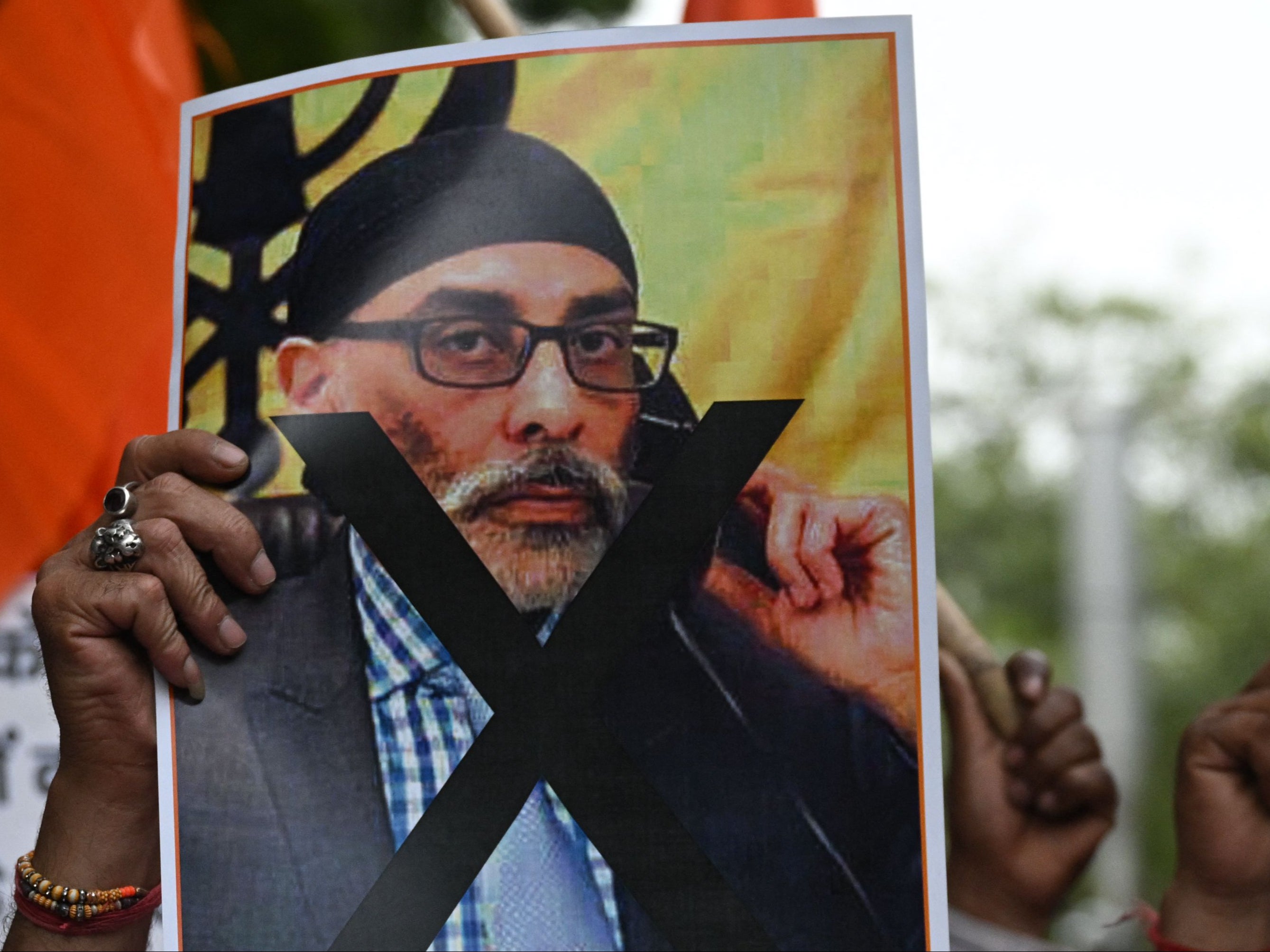 A member of United Hindu Front organisation holds a banner depicting Gurpatwant Singh Pannun, a lawyer believed to be based in Canada designated as a Khalistani terrorist by the Indian authorities during a rally along a street in New Delhi on 24 September 2023