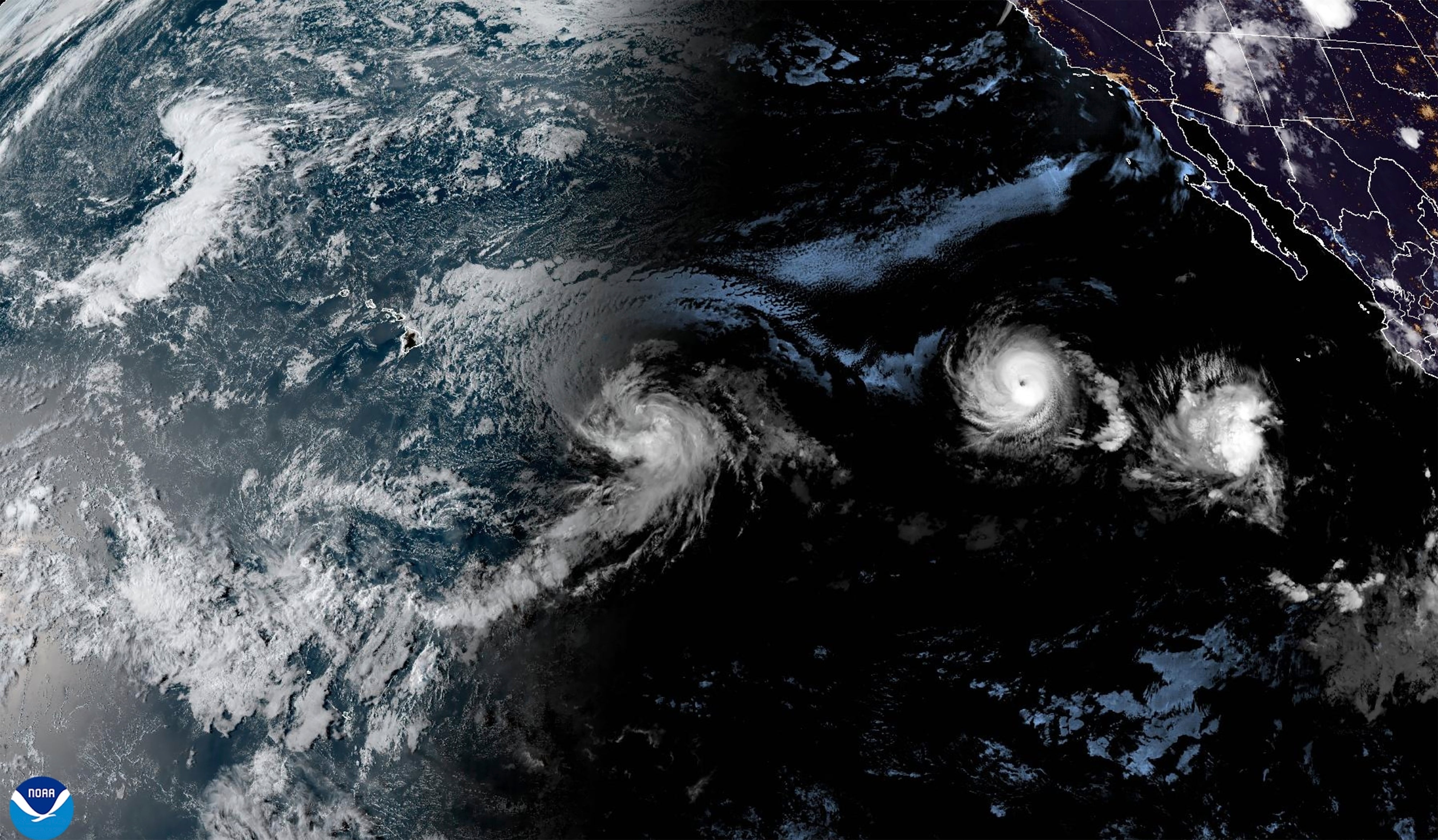 A NOAA satellite image shows Tropical Storm Hone and Hurricane Gilma over the Pacific Ocean on Thursday