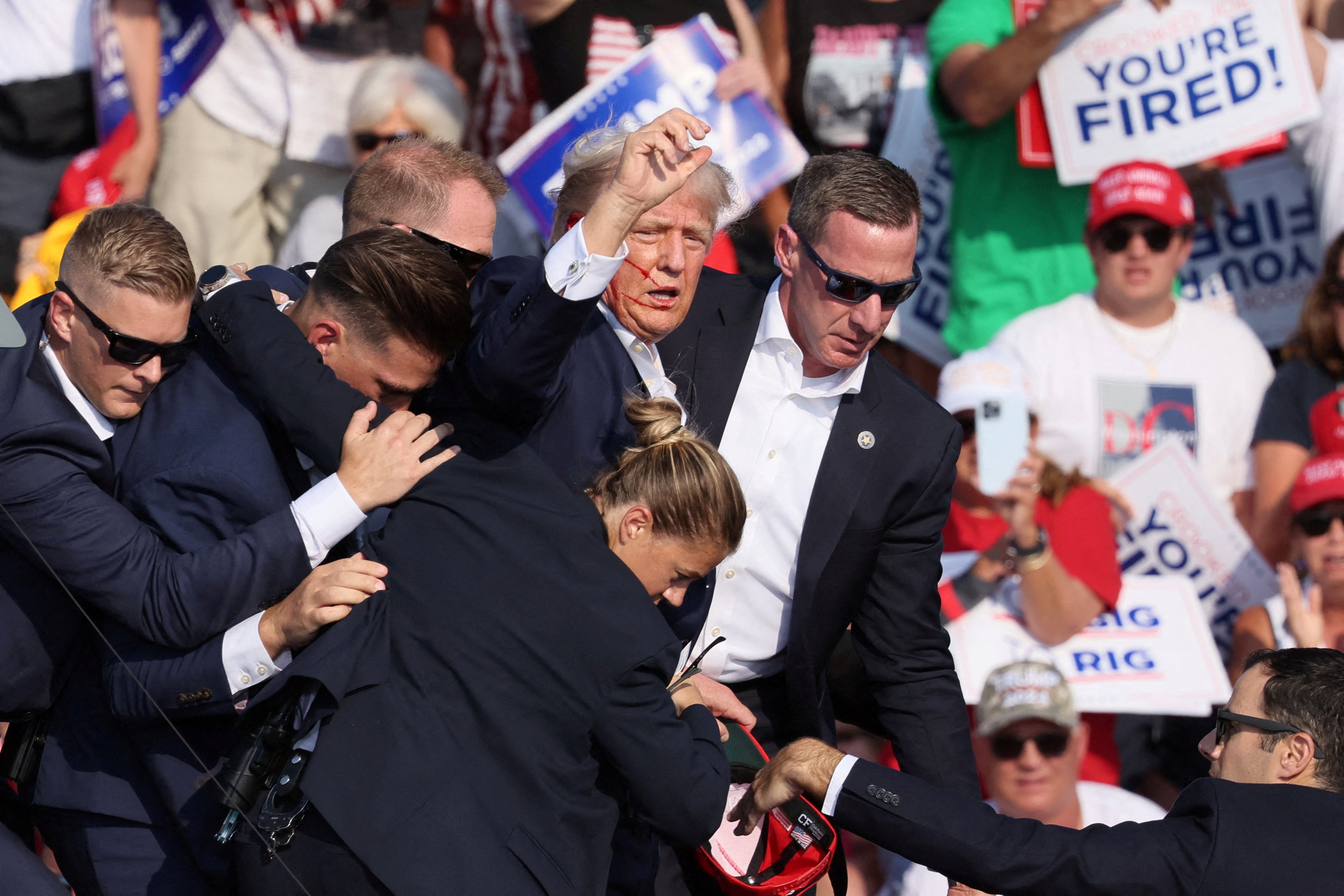 Members of Donald Trump’s Secret Service detail surround him after shots were fired at his rally in Butler, Pennsylvania on July 13.