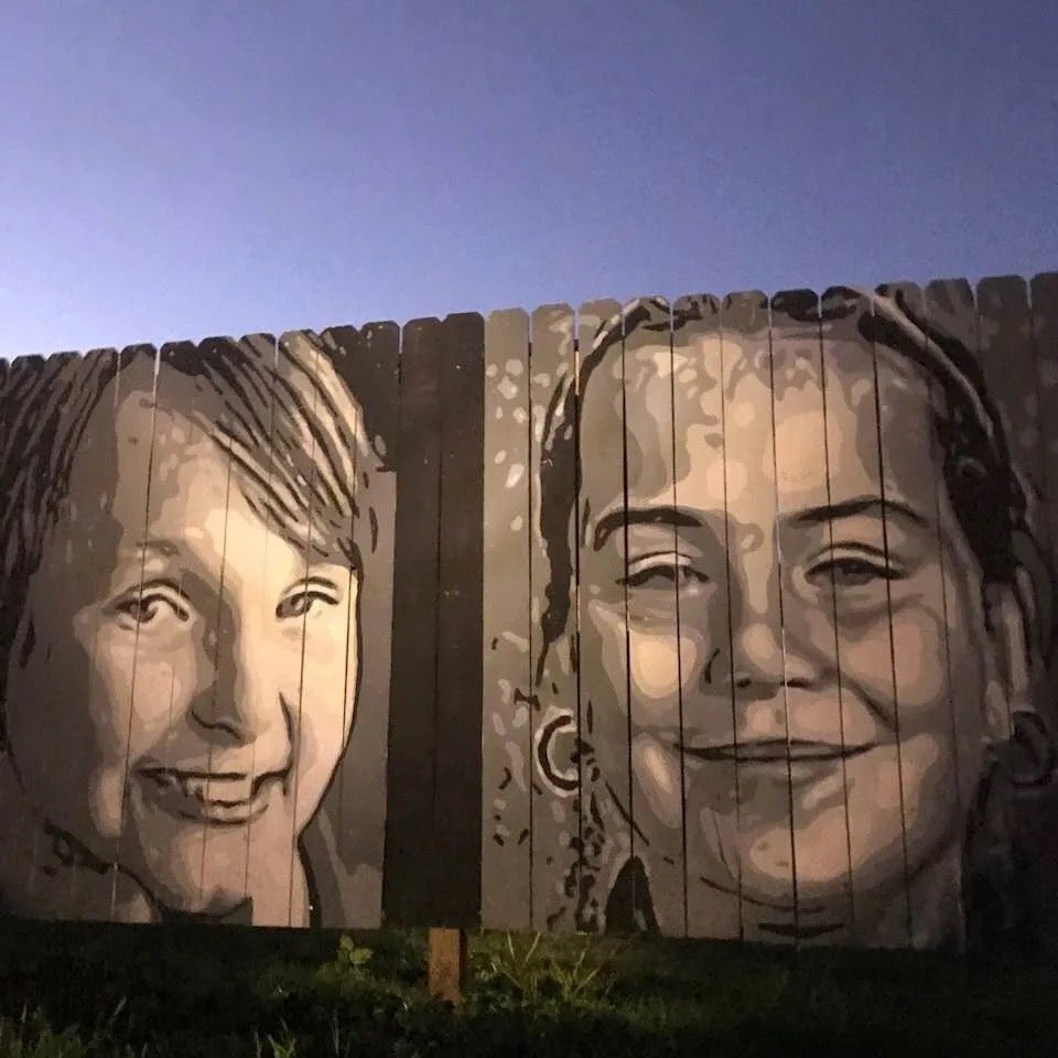 A mural of the cousins etched onto a fence