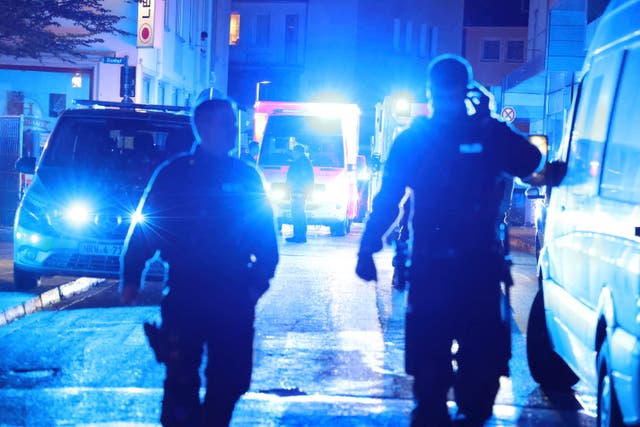 <p>Police and ambulances near the scene where three people have been killed and four others are fighting for their lives after an attack at a festival in Germany</p>