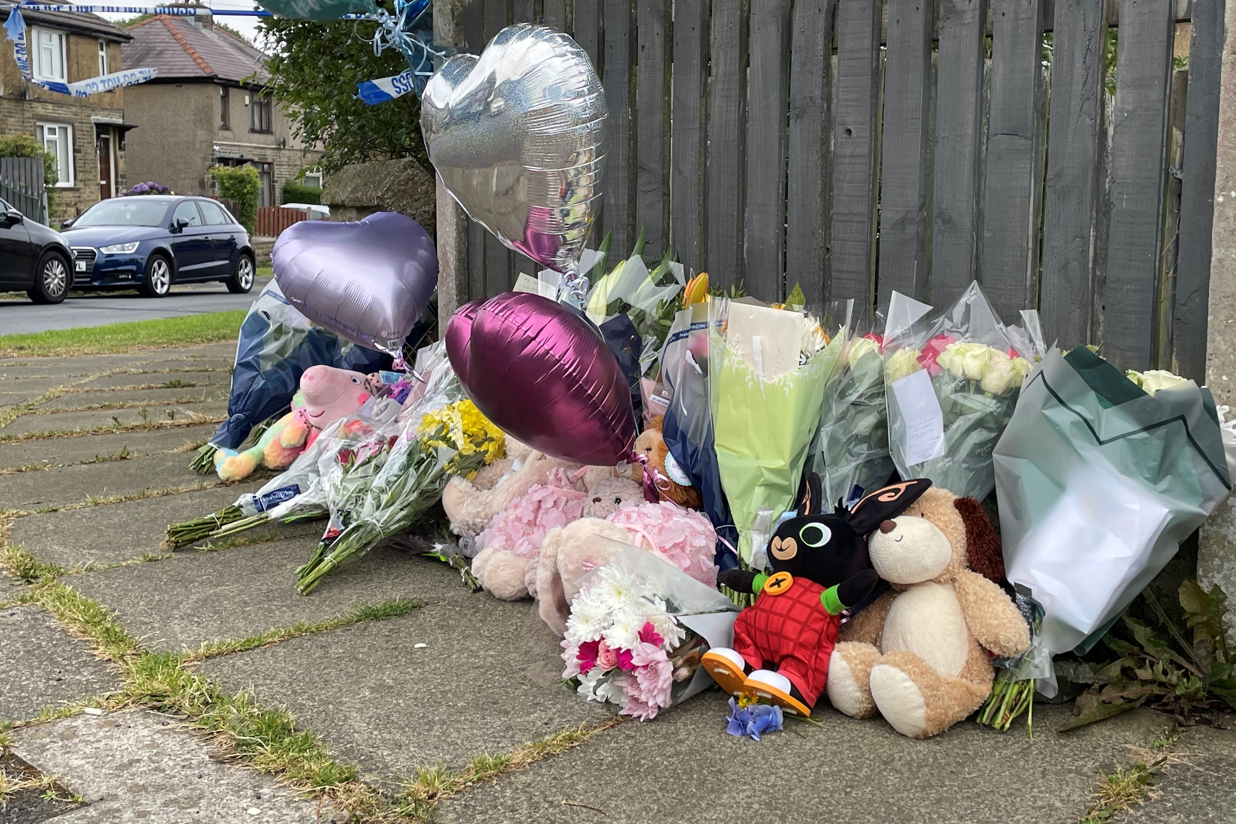 Flowers and tributes lie near the scene of the deaths in Bradford