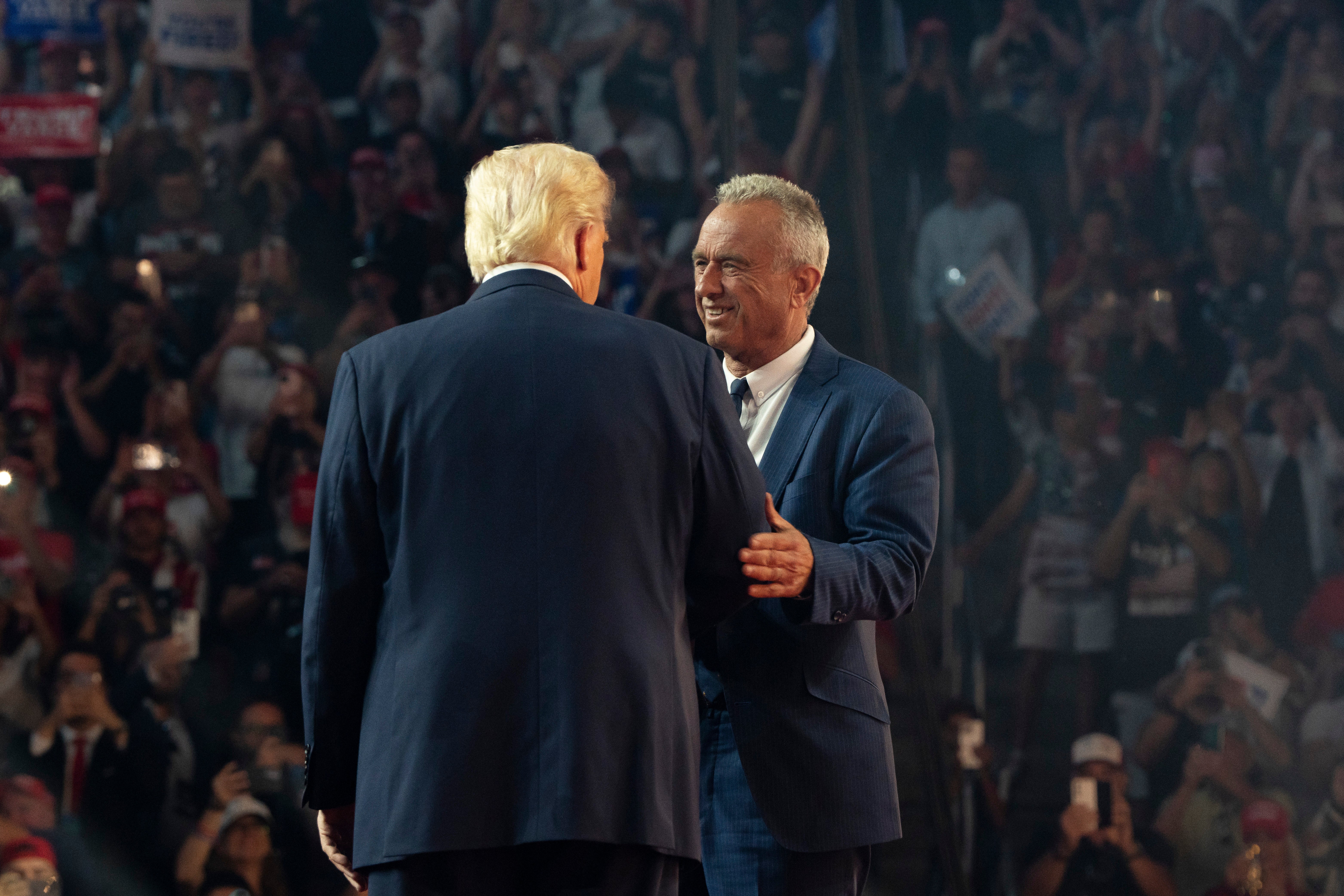 Robert F. Kennedy Jr. greets Donald Trump during a campaign rally at Desert Diamond Arena in Glendale, Arizona. Trump said he would establish a commission on assassination attempts if elected