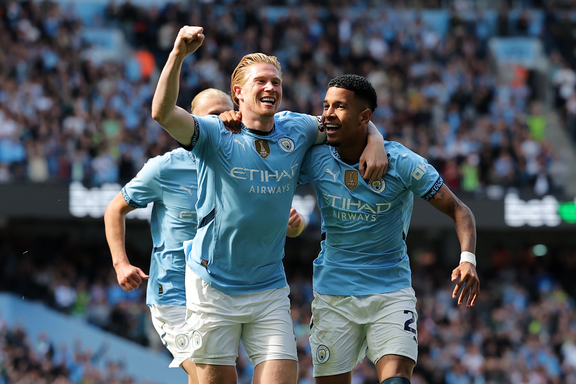 Kevin De Bruyne of Manchester City celebrates with teammate Savinho