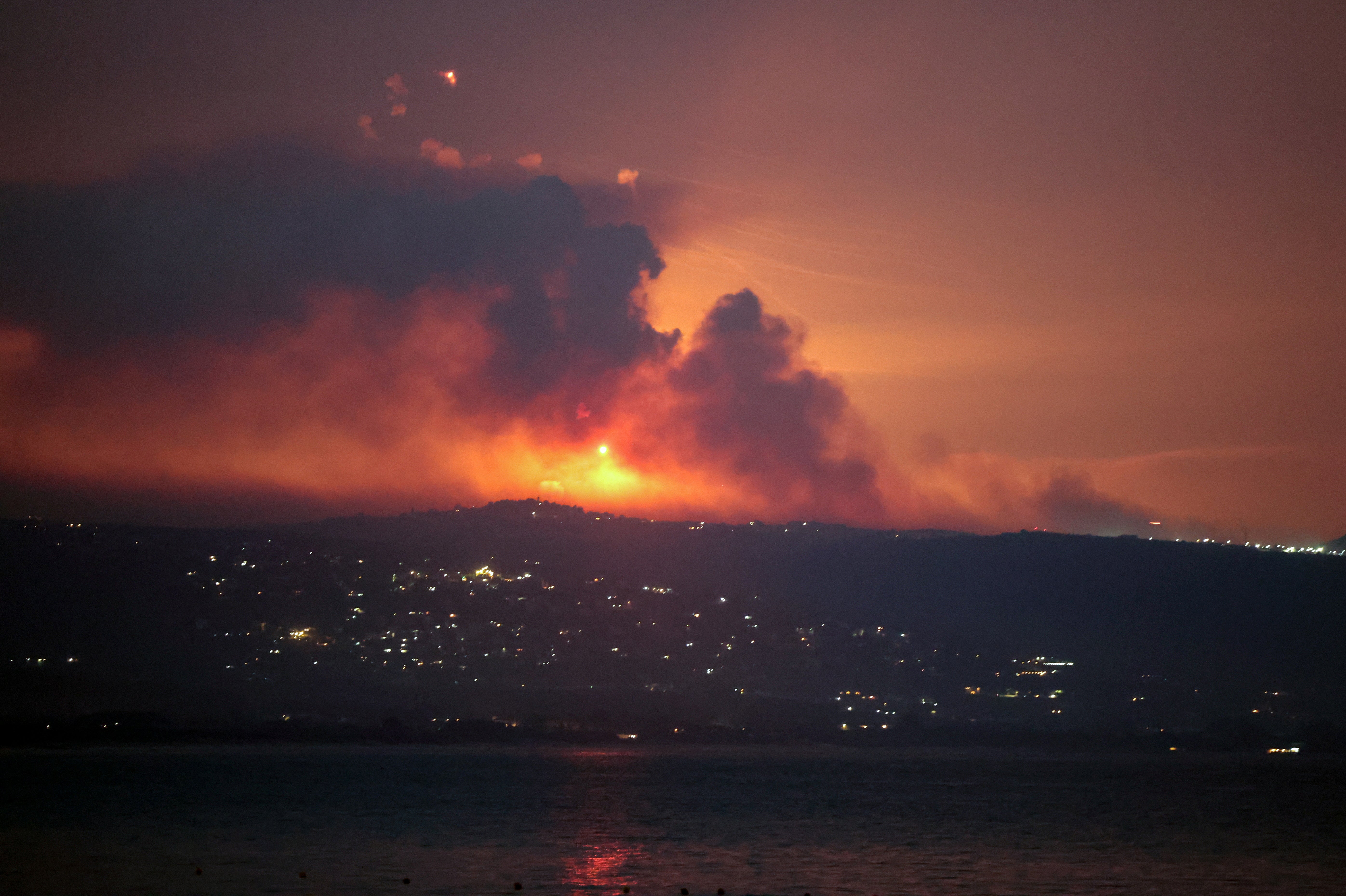 Smoke and fire on the Lebanese side of the border with Israel, as seen from Tyre, southern Lebanon