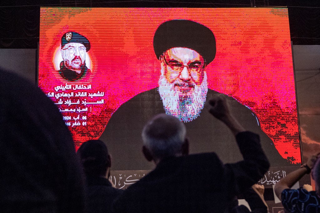 A supporter cheers while listening to Hezbollah leader Sayyed Hassan Nasrallah via a video link during a ceremony to mark the first week since the killing of Hezbollah’s top commander Fuad Shukr on 6 August