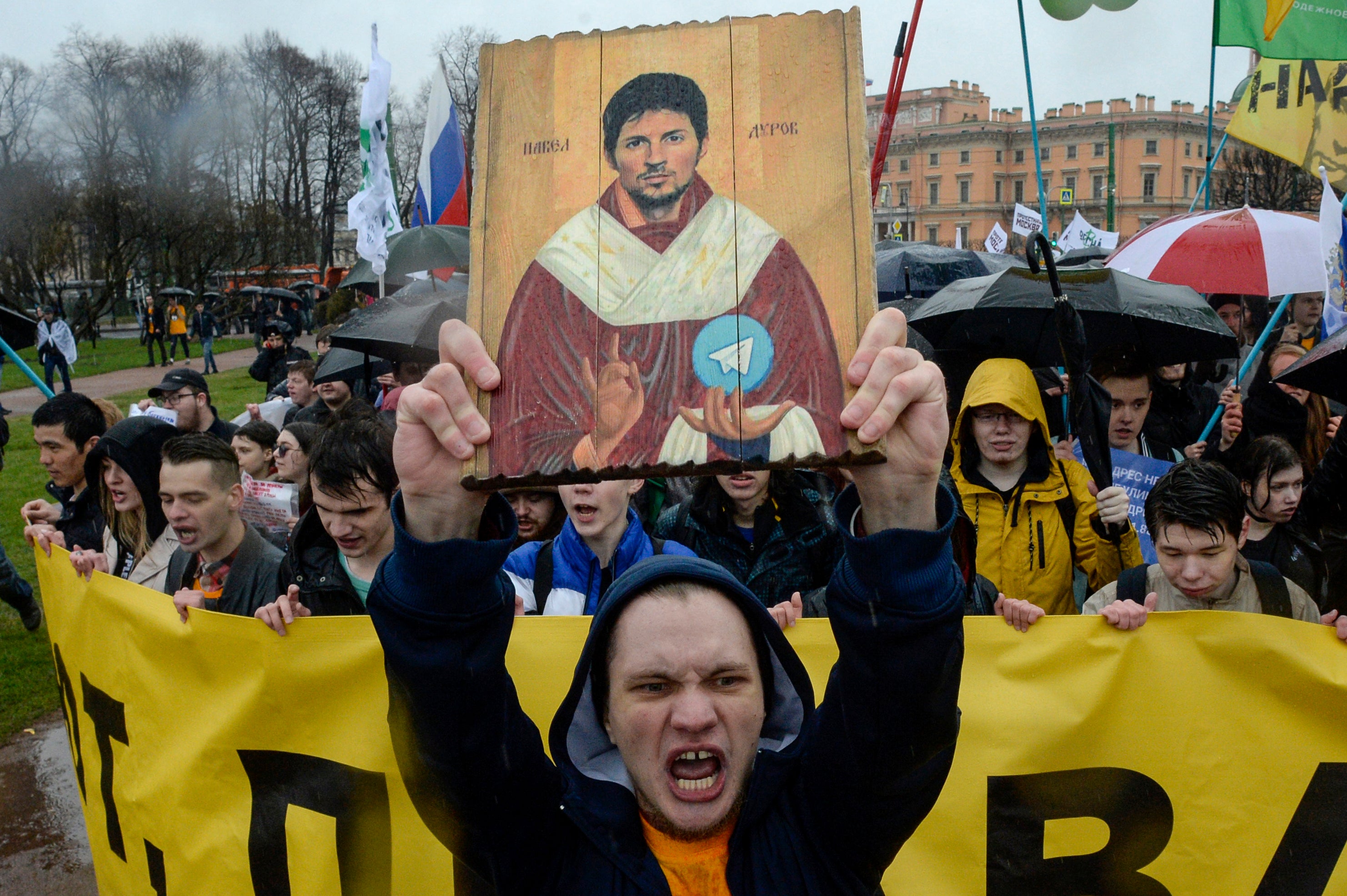 Russian demonstrators carry a painting depicting Telegram founder Pavel Durov as they protest against the blocking of the messaging app in Saint Petersburg on 1 May 2018.