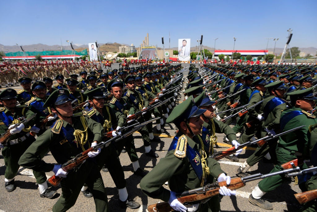 Houthi soldiers march during an official military parade marking the ninth anniversary of the Houthi takeover of the Yemeni capital, Sanaa