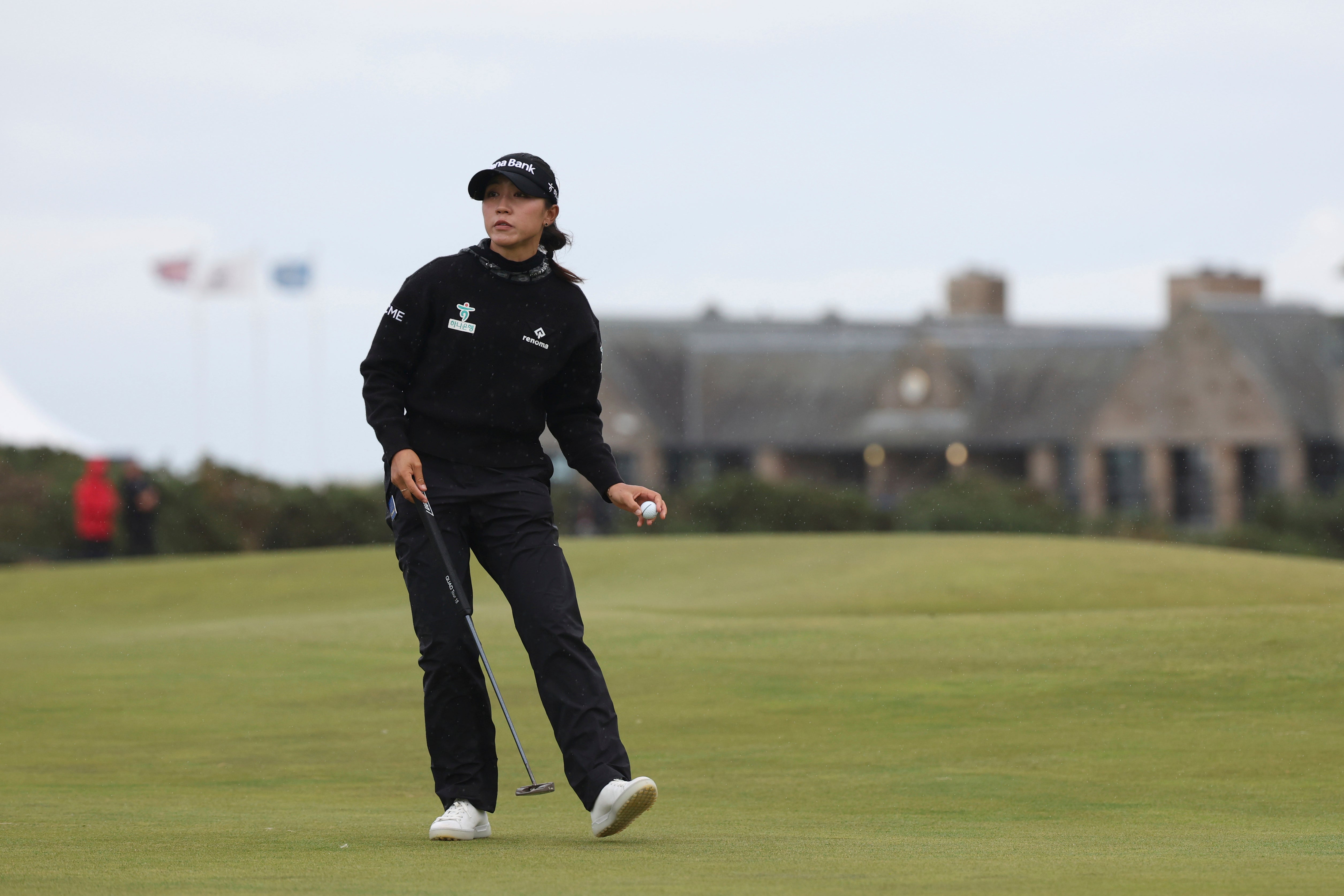 Lydia Ko plucks her ball from the 16th hole