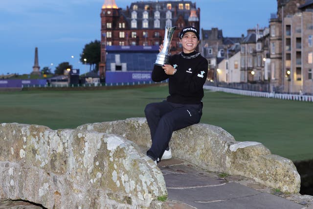 <p>Lydia Ko poses on the Swilcan Bridge after her victory at the Open</p>