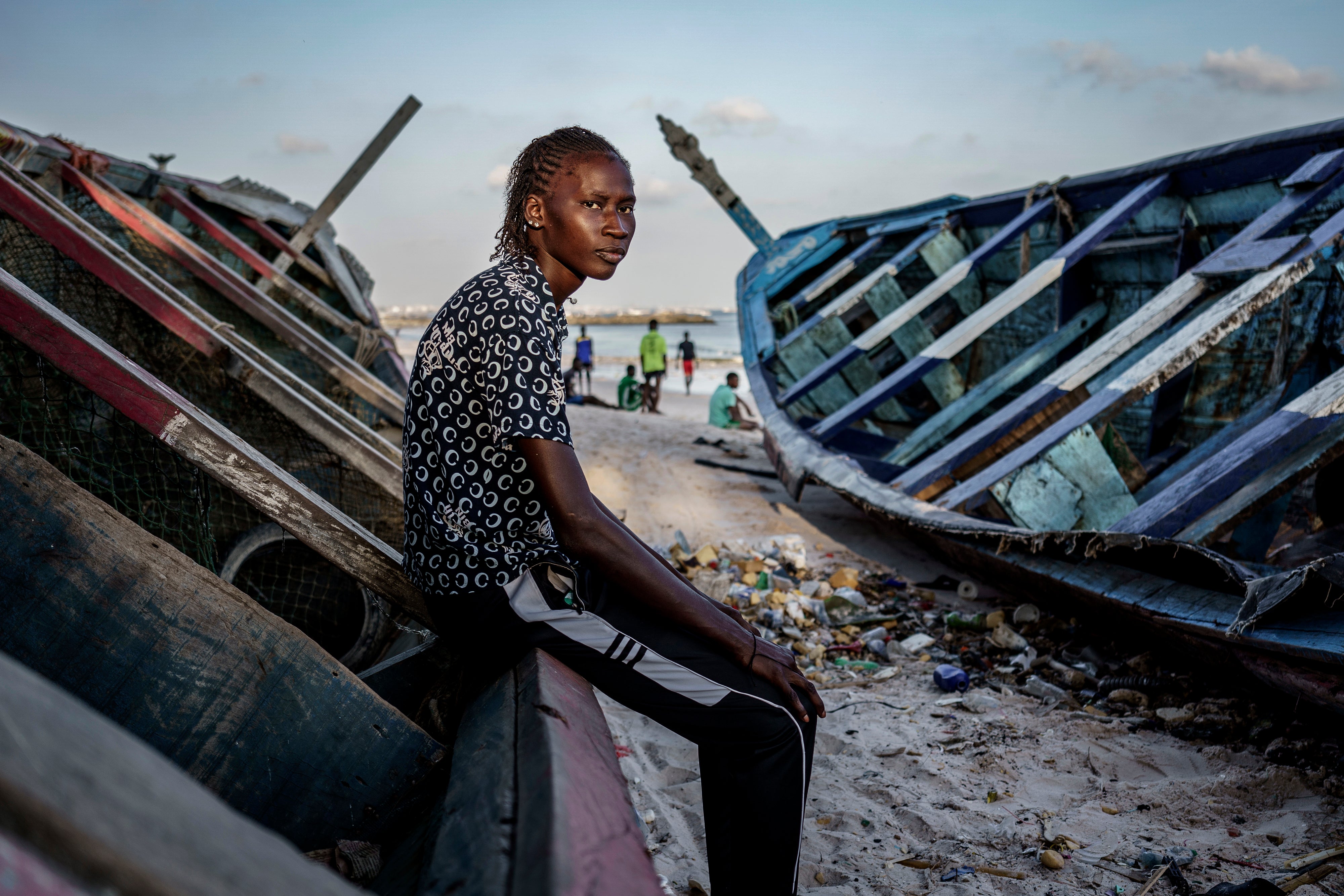 Salamba Ndeye, a 28-year-old who tried to migrate to Europe twice, poses for a photo at the beach in Thiaroye-Sur-Mer, Senegal, Friday, Aug. 23, 2024