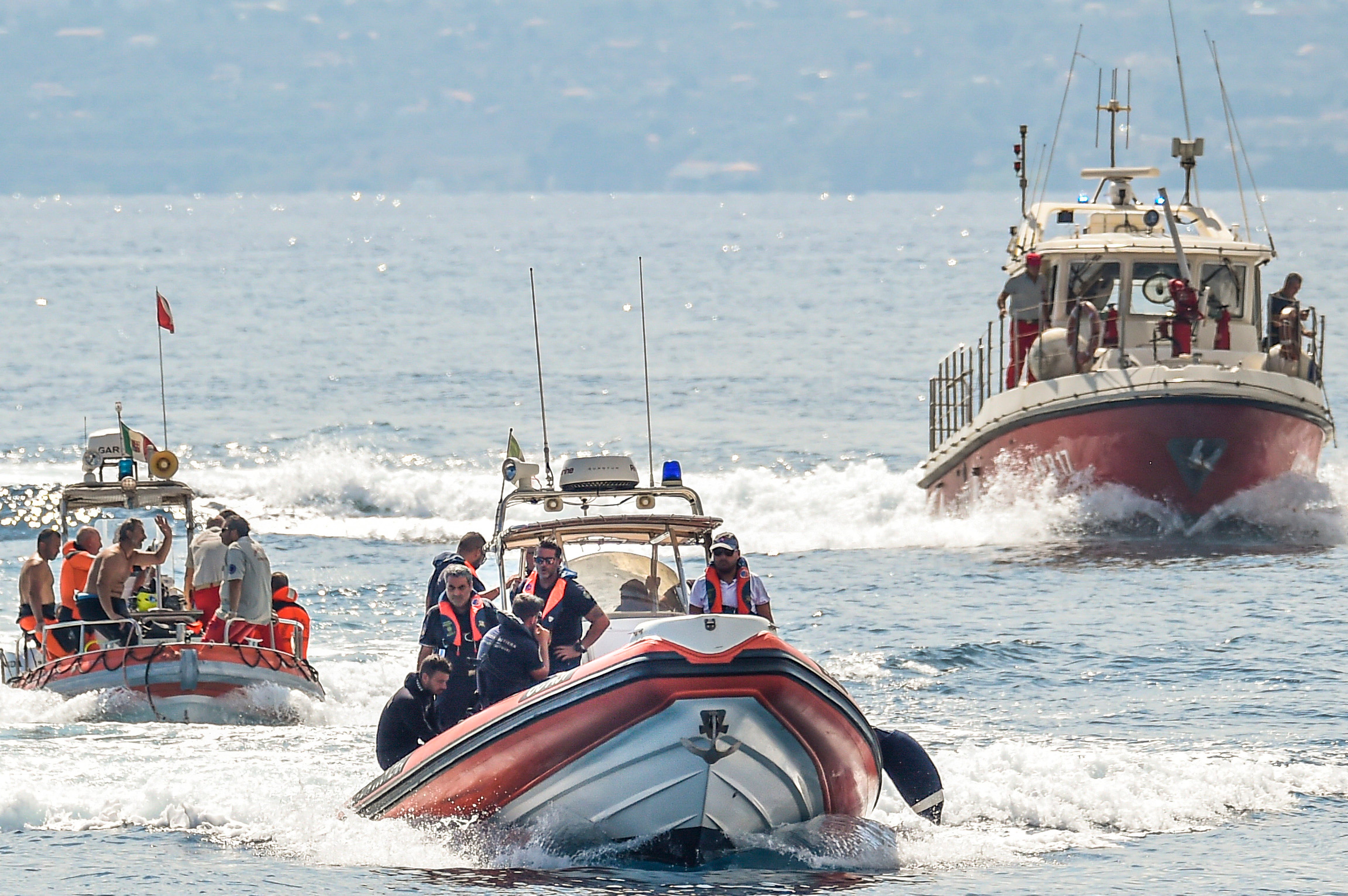 Italian firefighter divers work at the site of a shipwreck, in Porticello, Sicily, southern Italy