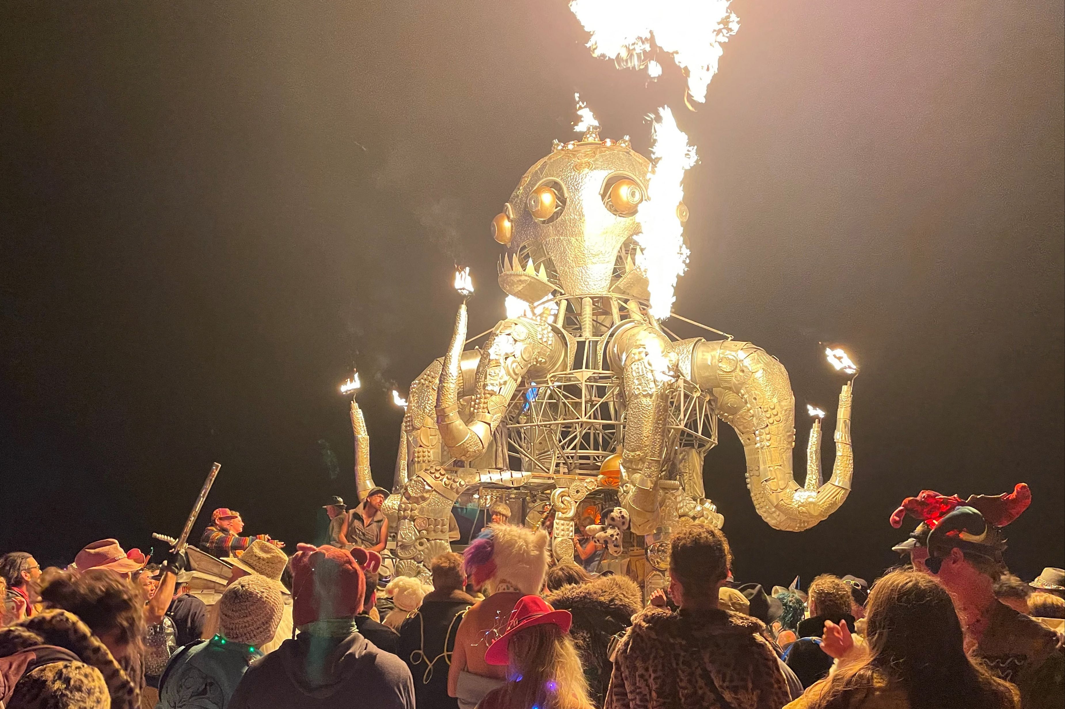 Attendees dance during the annual Burning Man Festival in the early morning of September 5, 2023