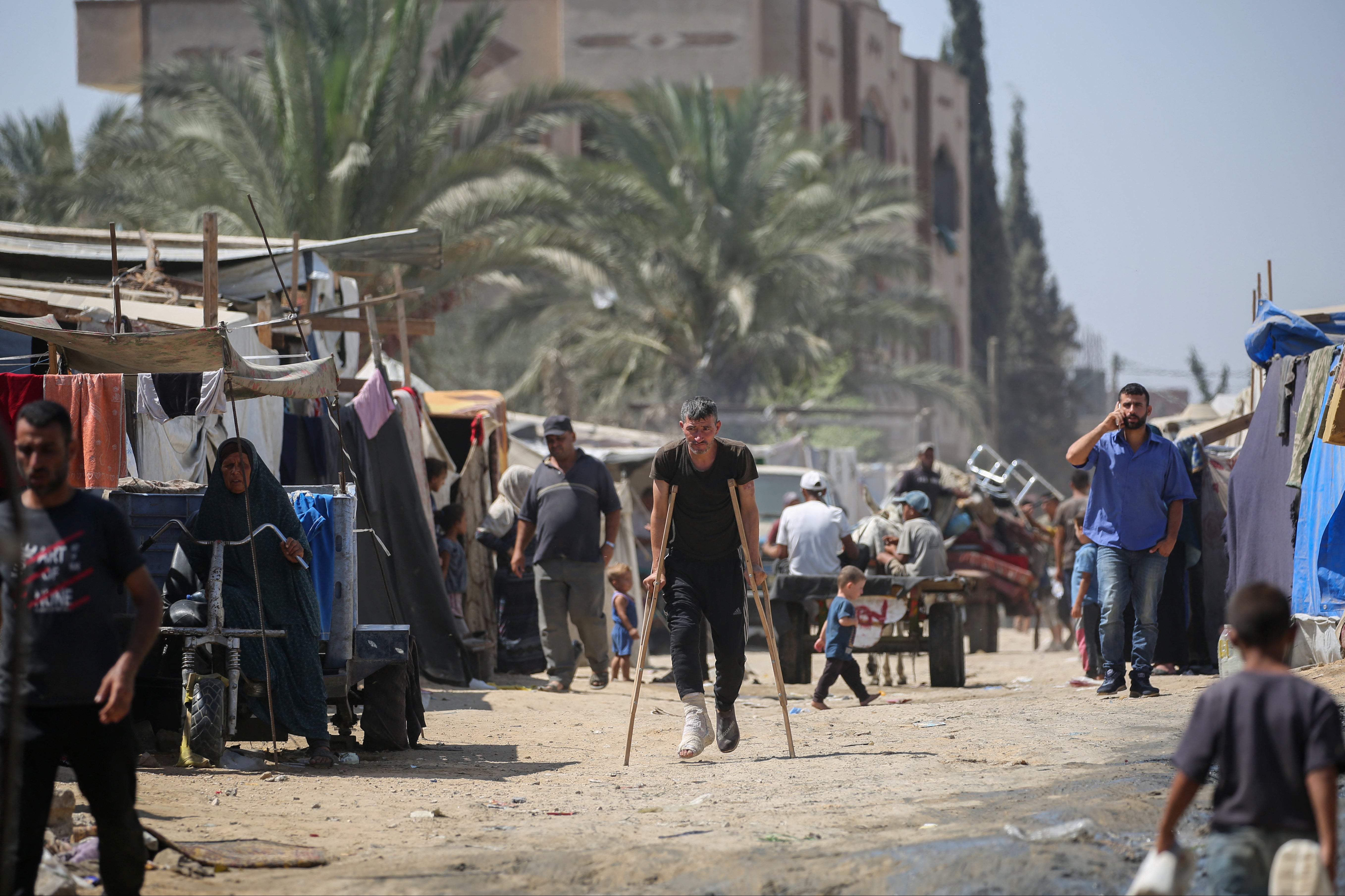 Displaced Palestinians prepare to leave the perimeter of the Al-Aqsa Martyrs Hospital in Deir al-Balah