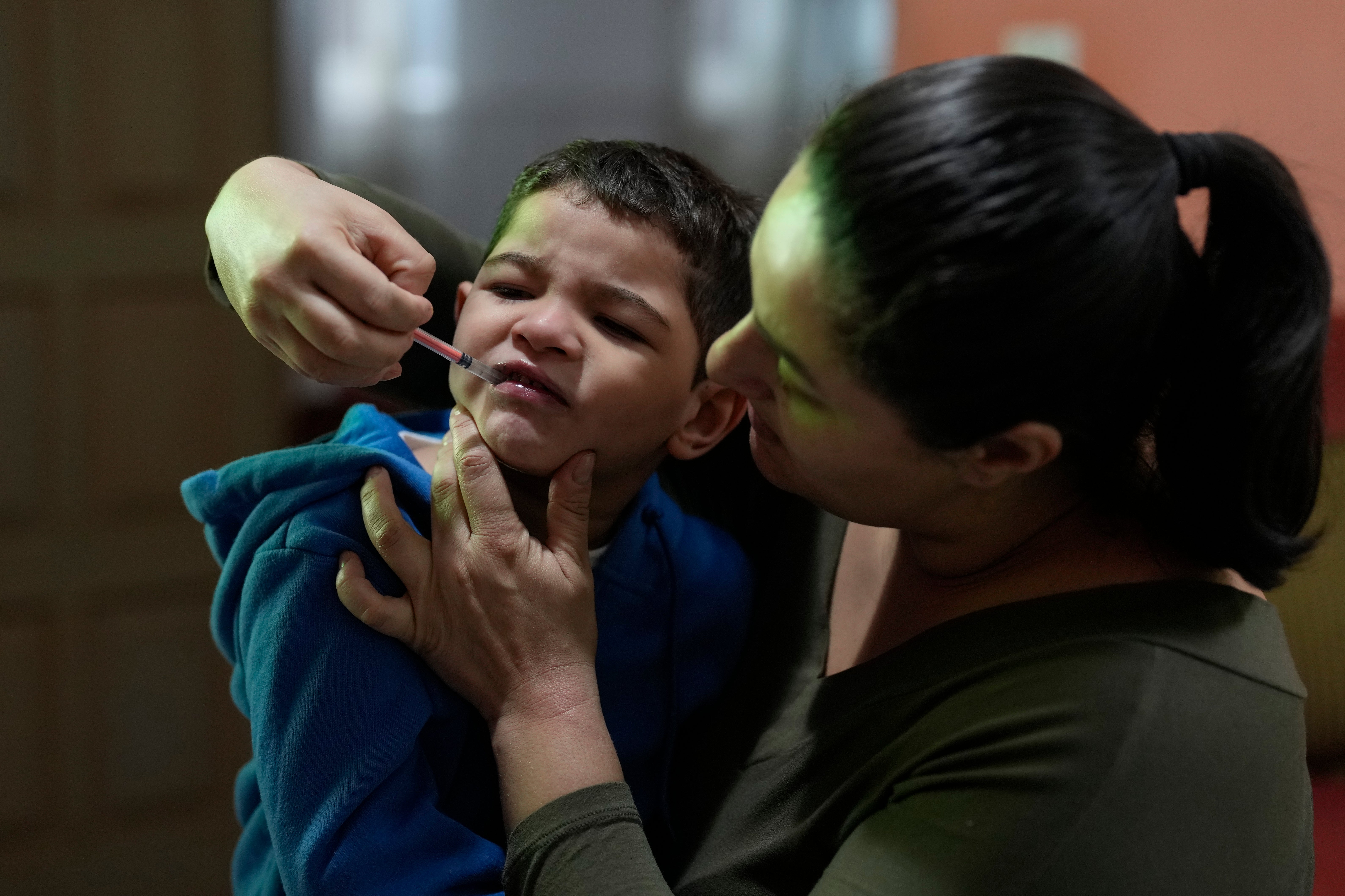 Janaina Silva gives a dose of cannabidiol or CBD, to her four-year-old son Murillo