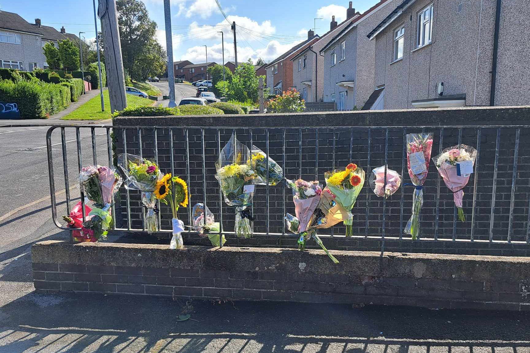 Floral tributes left at the scene in Heights Drive, Wortley, following the death of parcel delivery driver Claudiu-Carol Kondor (Matt Gibson/PA)